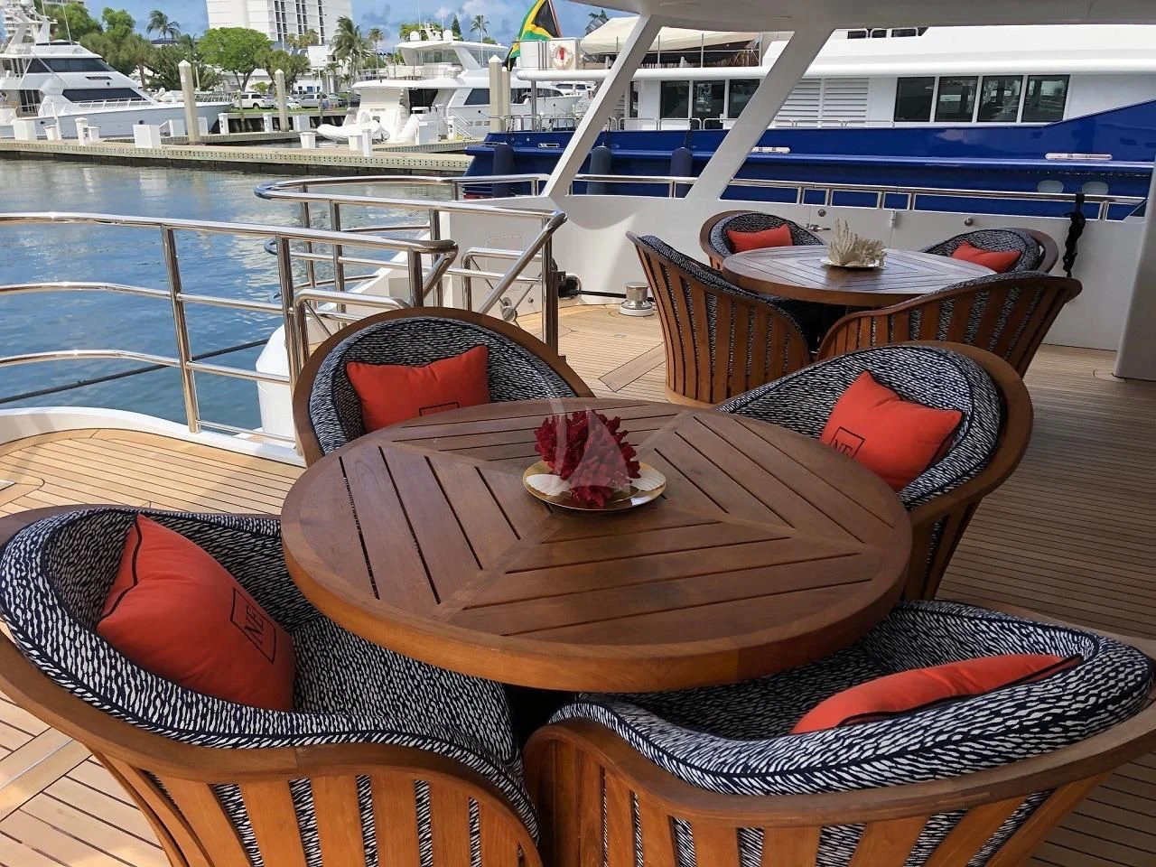 a table with chairs on it next to a body of water aboard NEVER ENOUGH Yacht for Charter