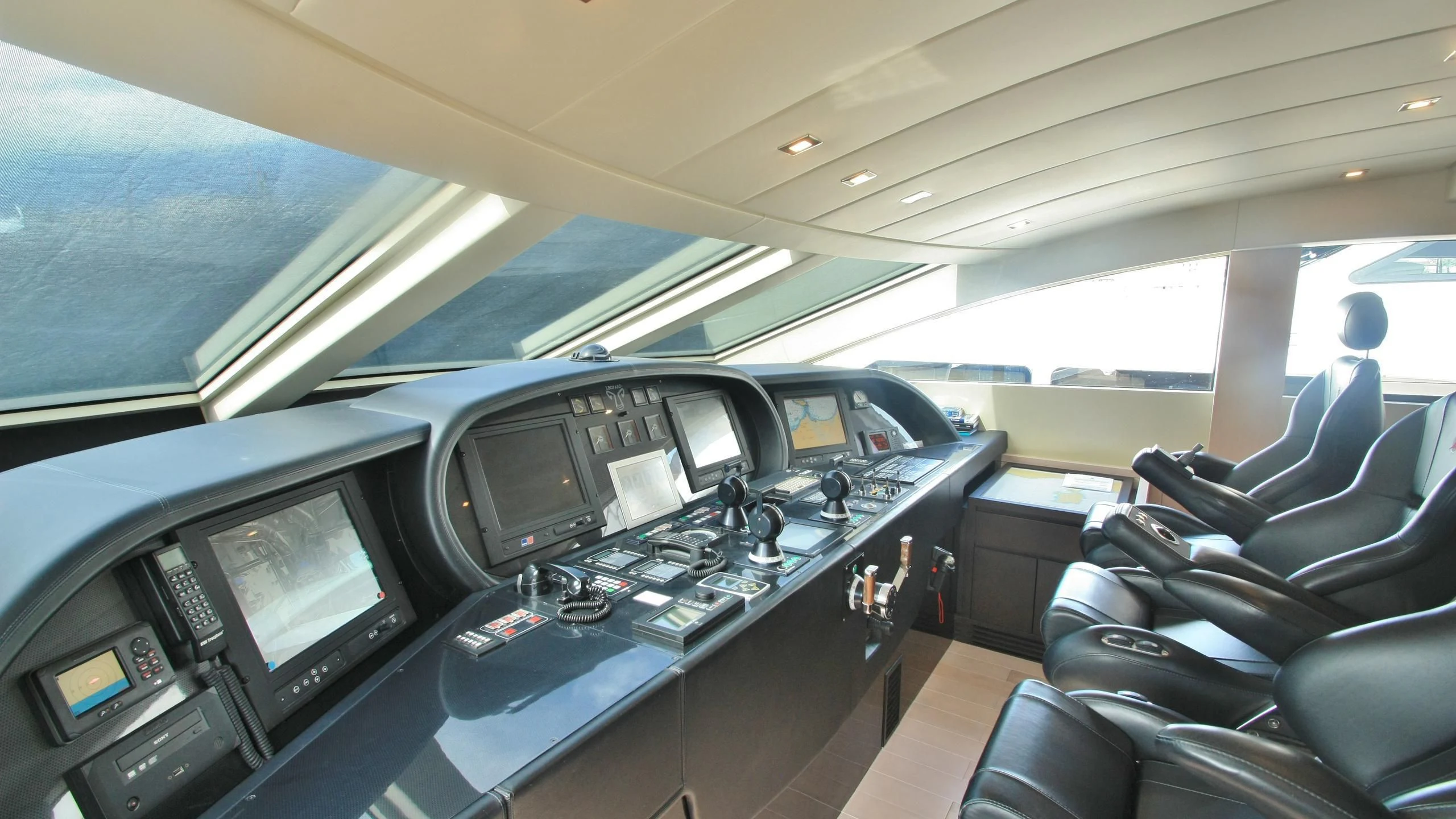 inside of a car with many monitors and seats aboard JADE Yacht for Sale