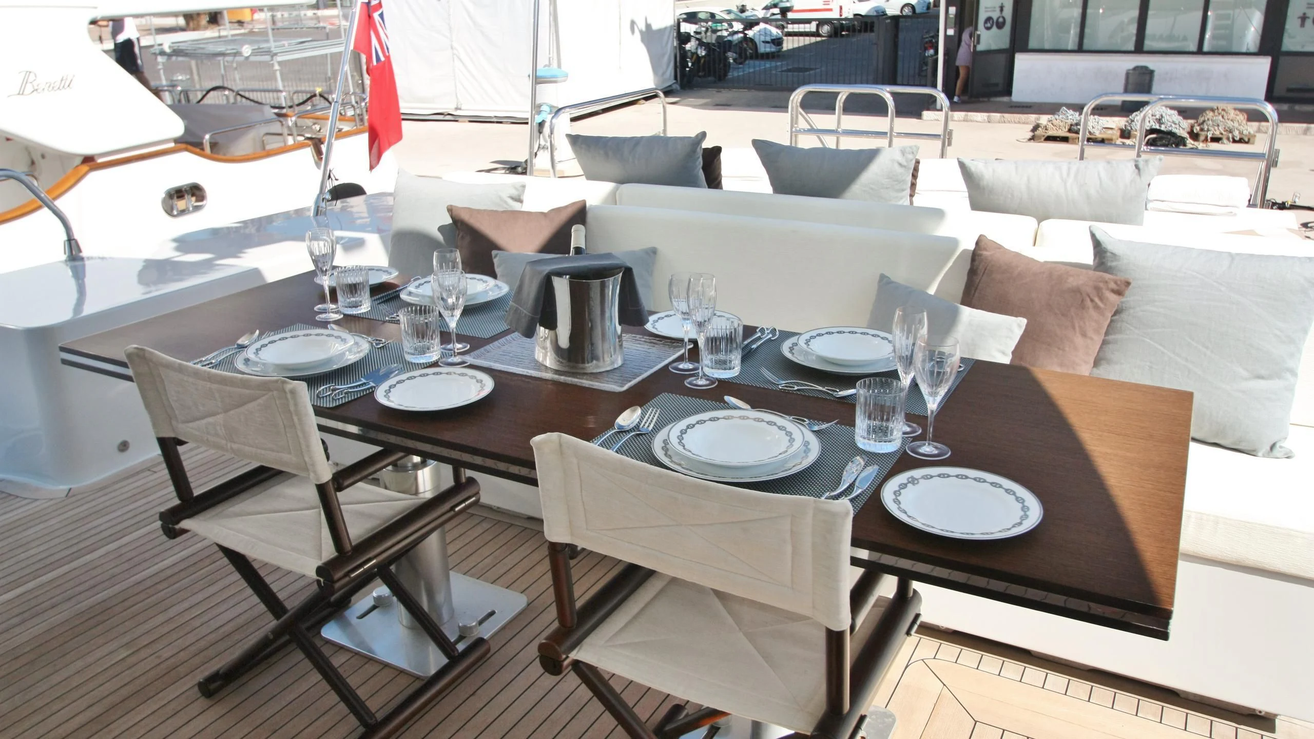 a table set with plates and glasses aboard JADE Yacht for Sale