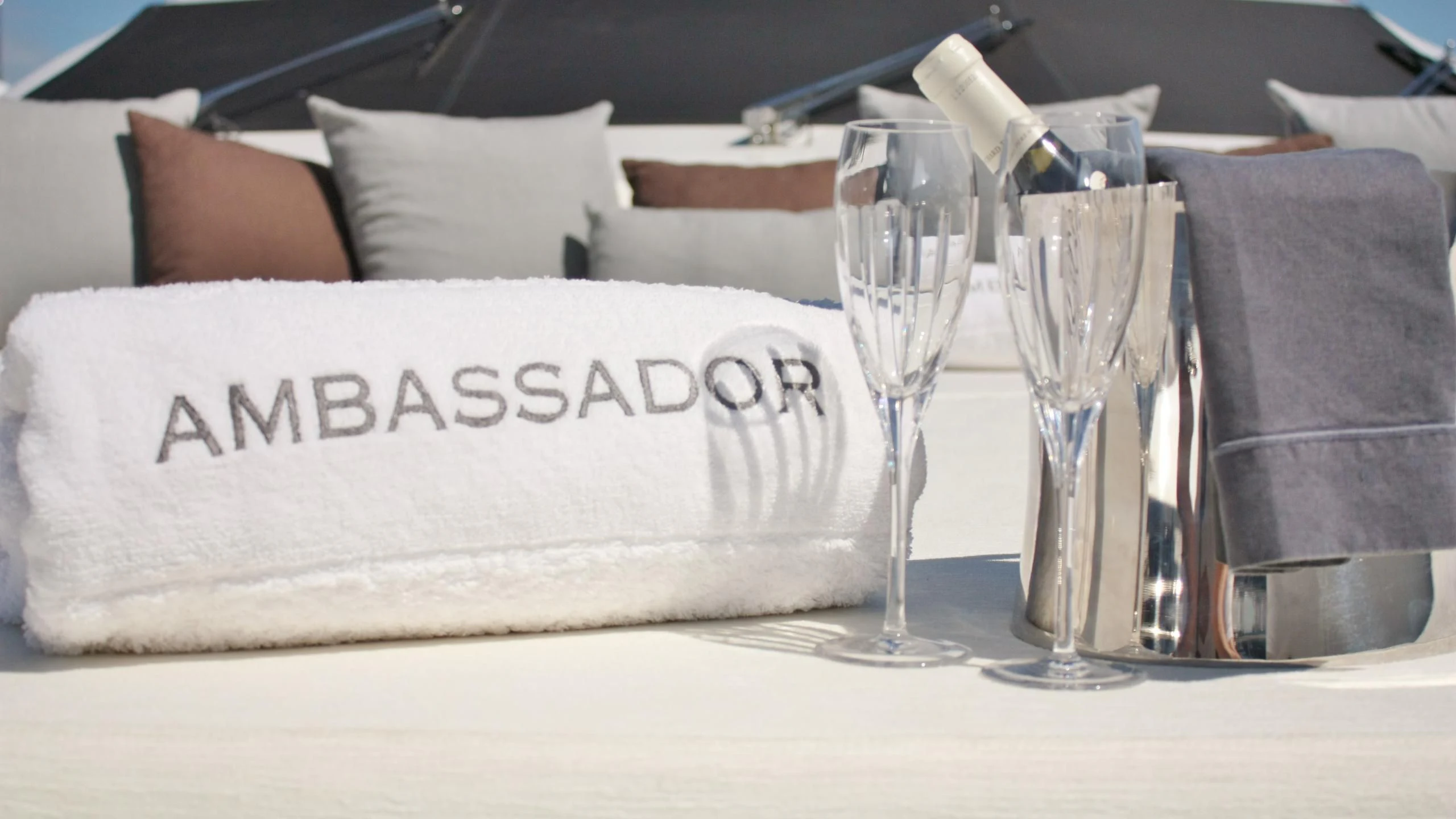 a plate with a napkin and glasses on it aboard JADE Yacht for Sale