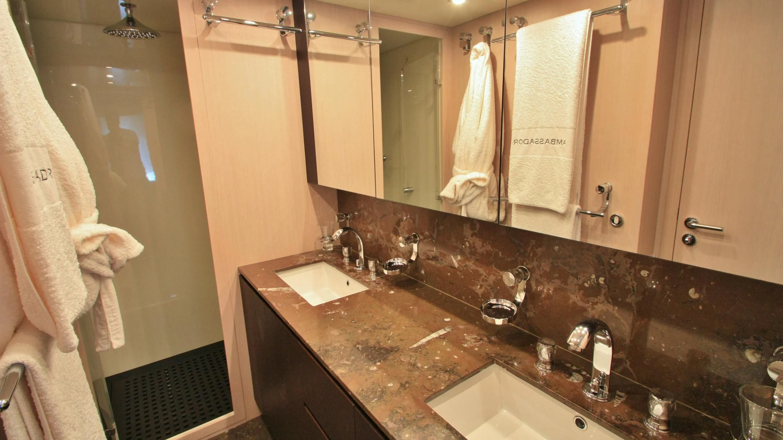 a bathroom with a countertop sink and towels aboard JADE Yacht for Sale