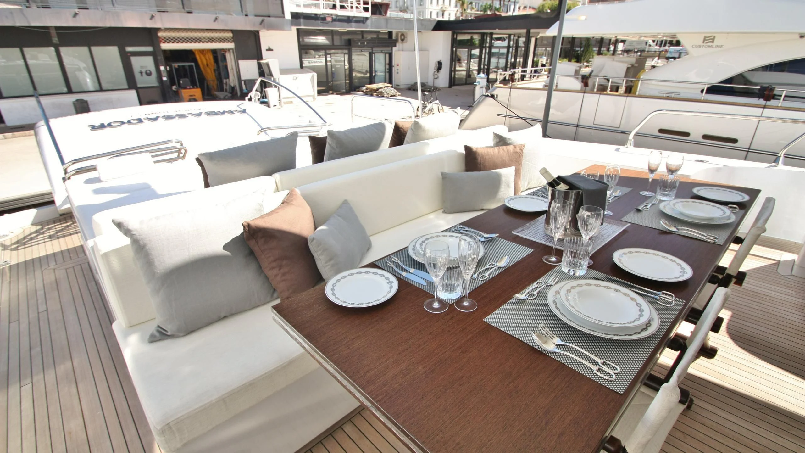 a table with plates and glasses on it aboard JADE Yacht for Sale
