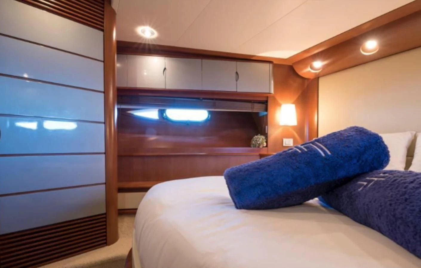 a bed with a blue pillow aboard 4F Yacht for Sale