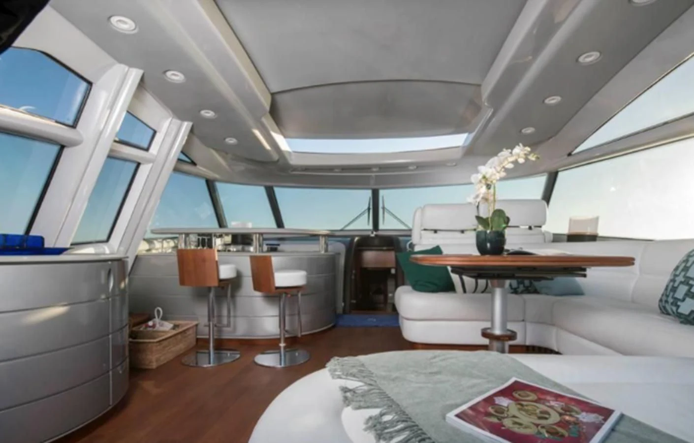 a room with a table and chairs aboard 4F Yacht for Sale