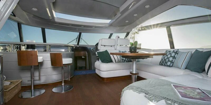 a room with a couch and a table and chairs aboard 4F Yacht for Sale