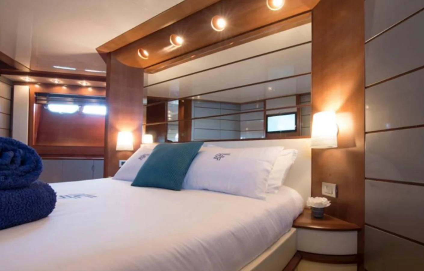 a bed with a white bed spread aboard 4F Yacht for Sale