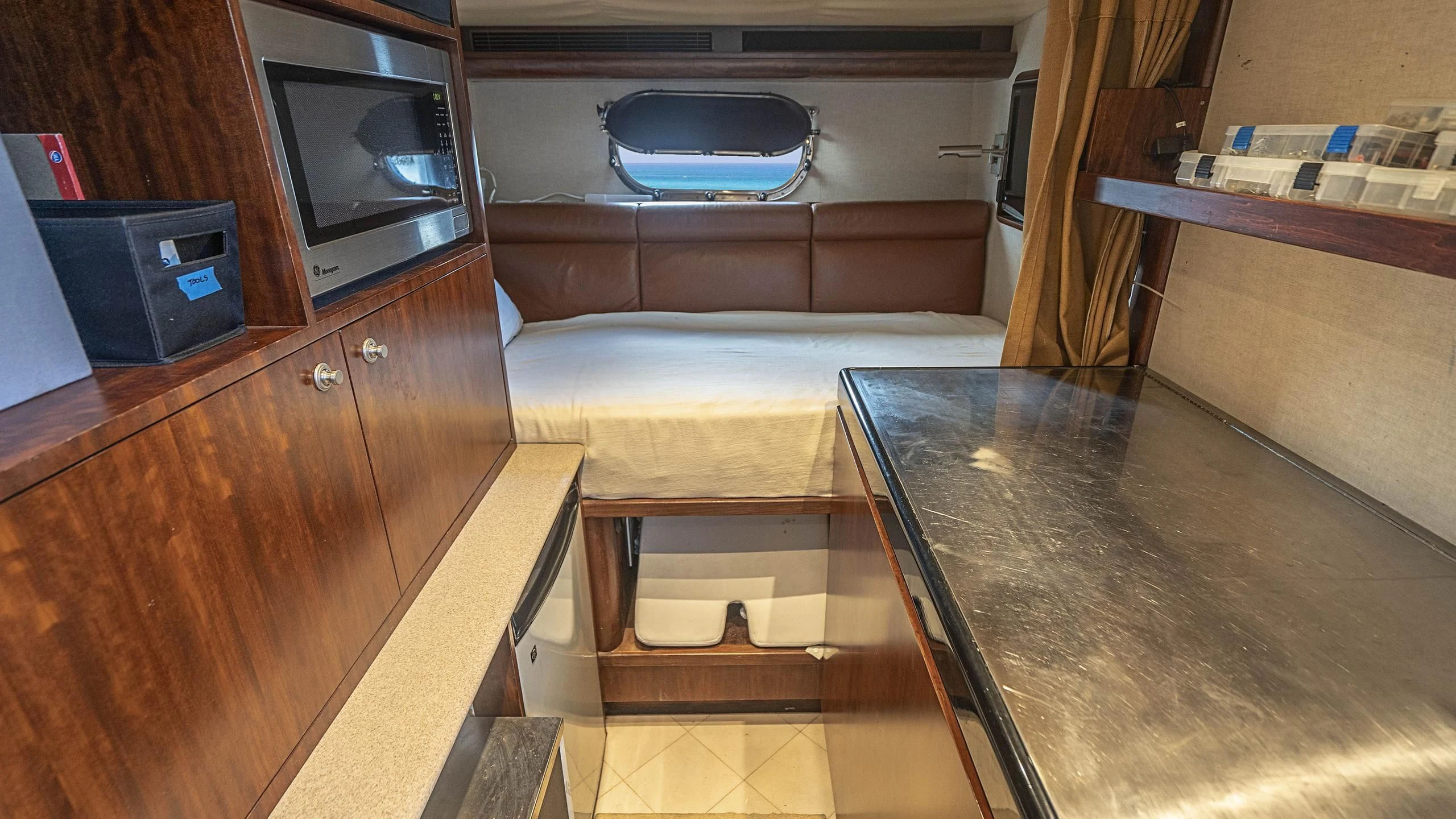 a living room with a couch and tv aboard GRAND LEGACY Yacht for Sale