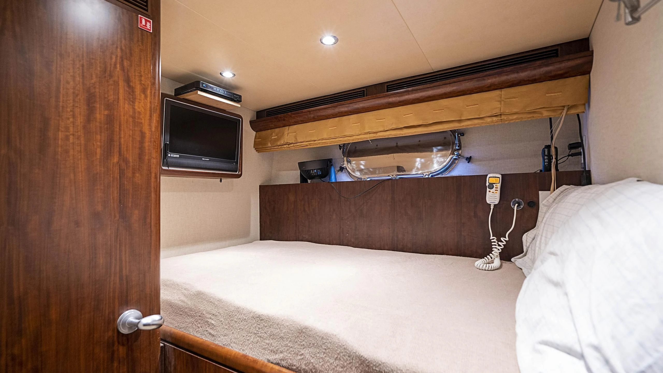 a bed and a television in a room aboard GRAND LEGACY Yacht for Sale