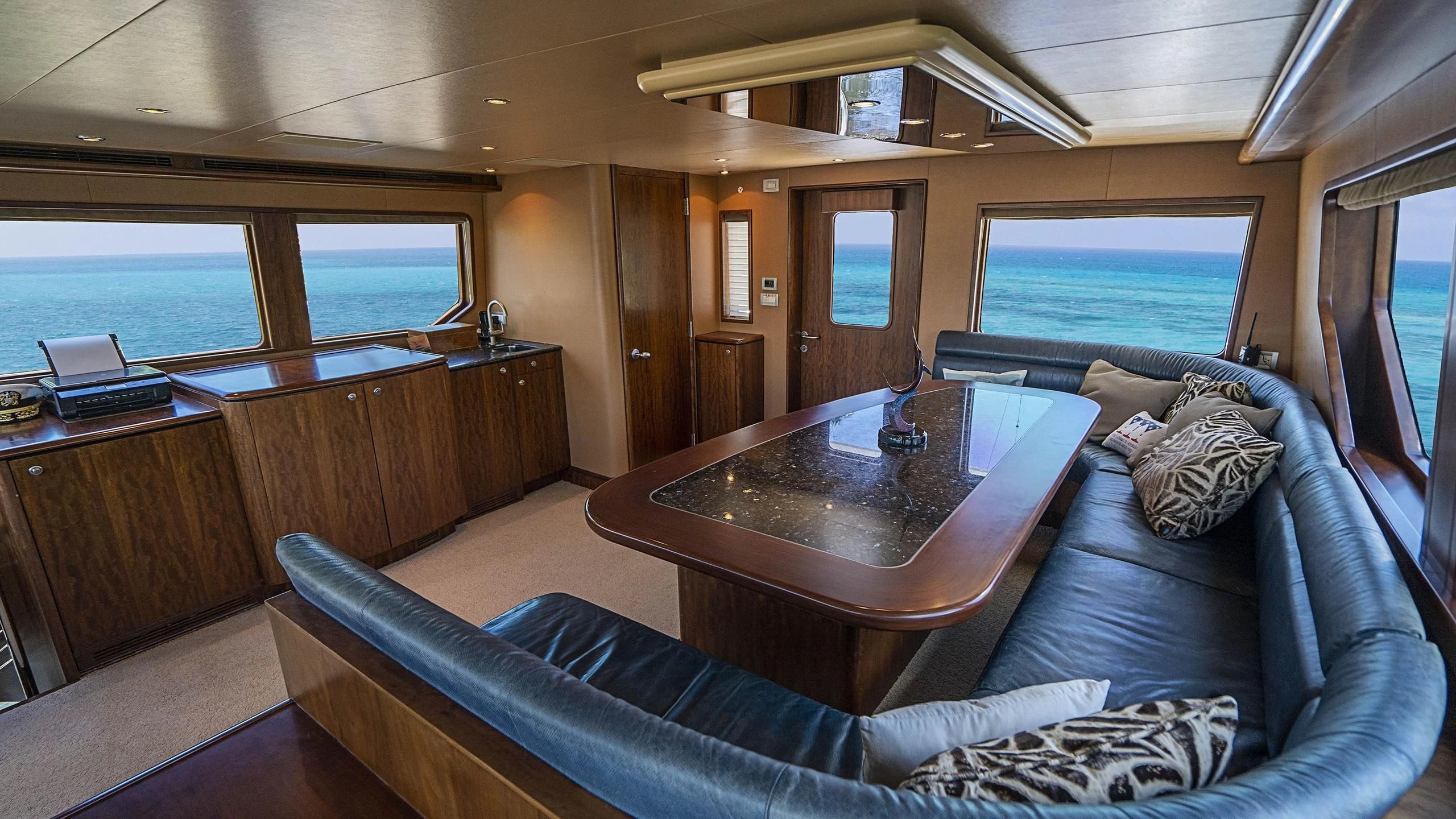 a living room with a couch and a coffee table aboard GRAND LEGACY Yacht for Sale