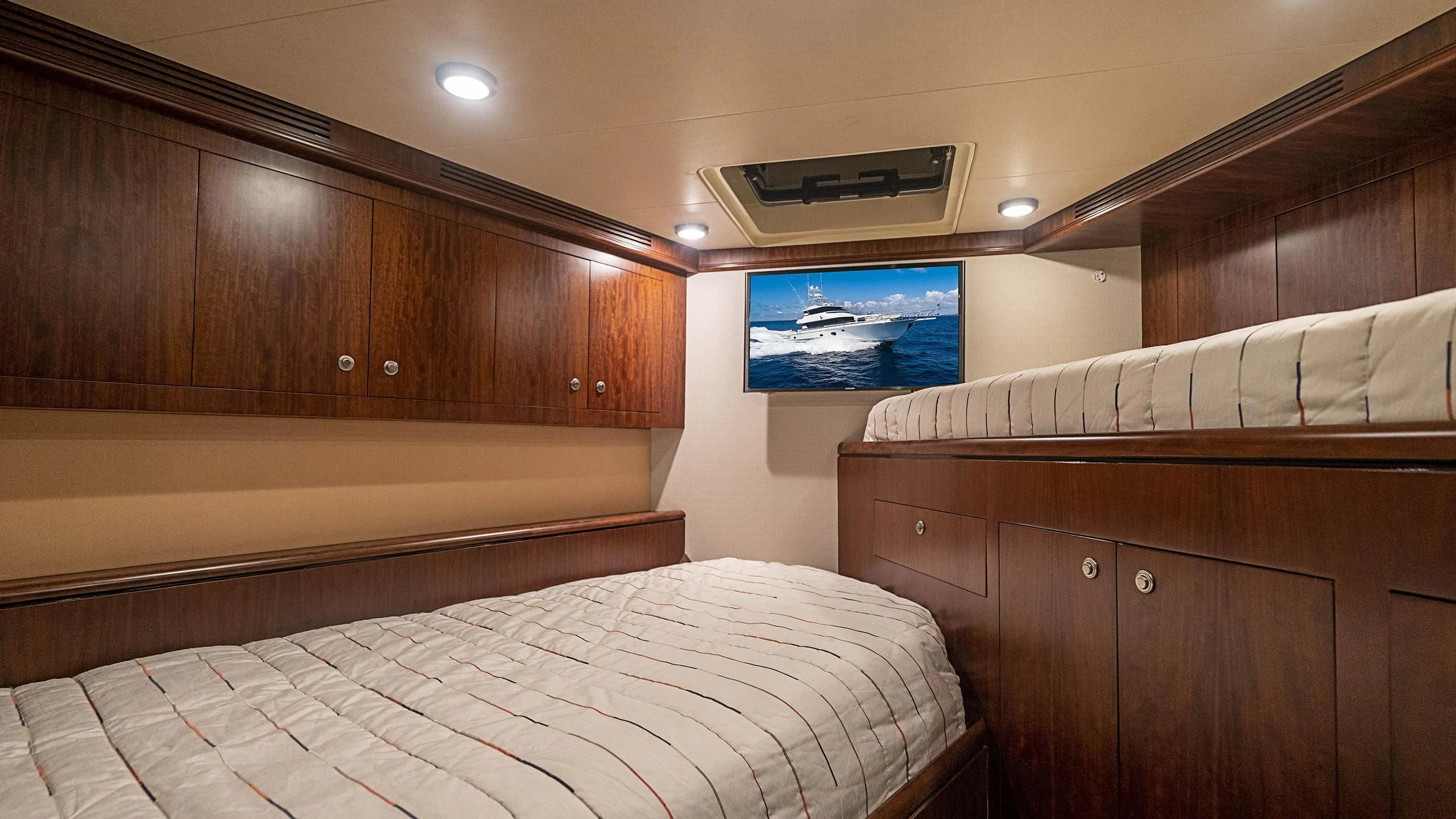 a room with wooden cabinets and a bed aboard GRAND LEGACY Yacht for Sale
