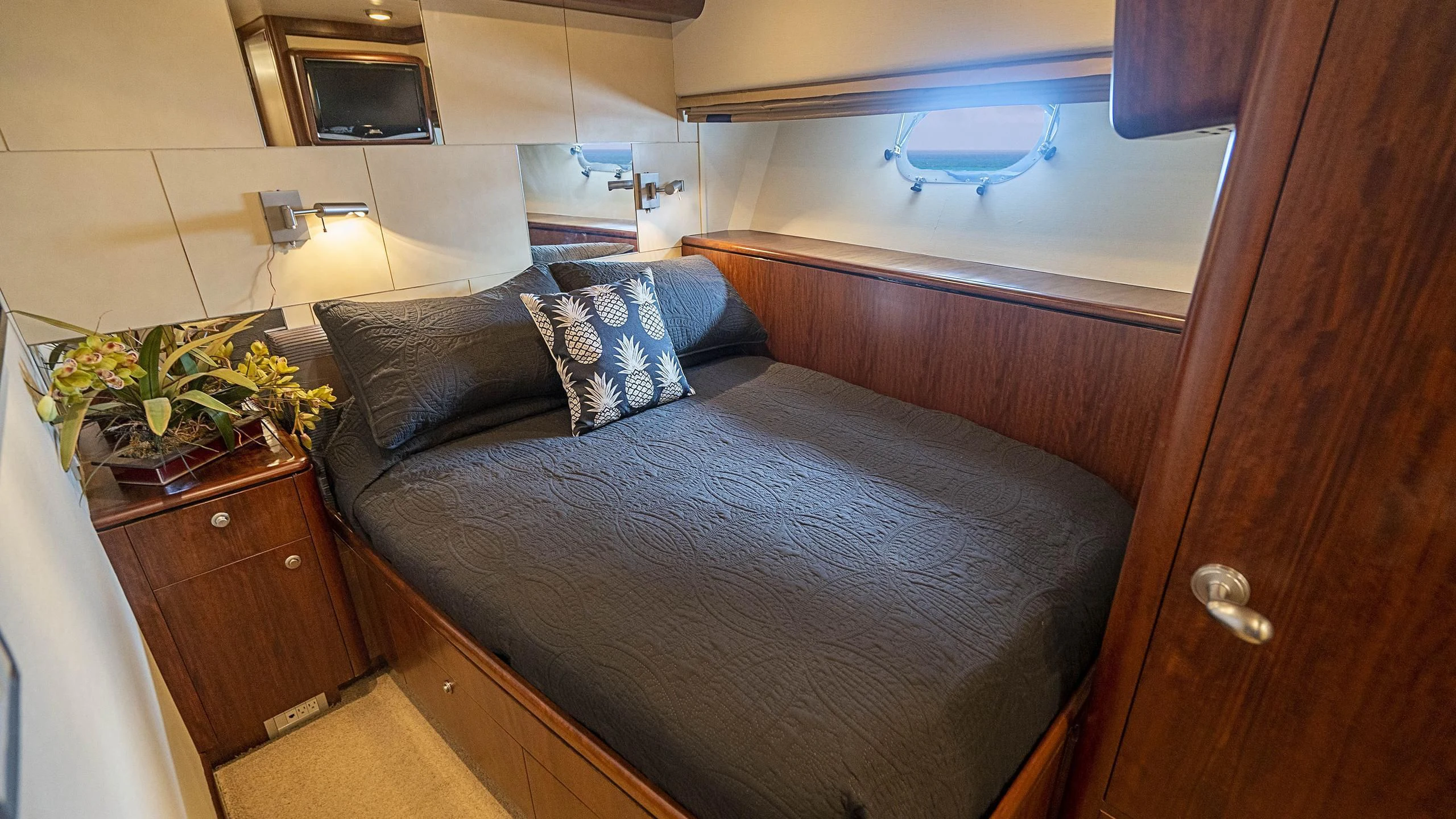 a bed with a flowered bed aboard GRAND LEGACY Yacht for Sale