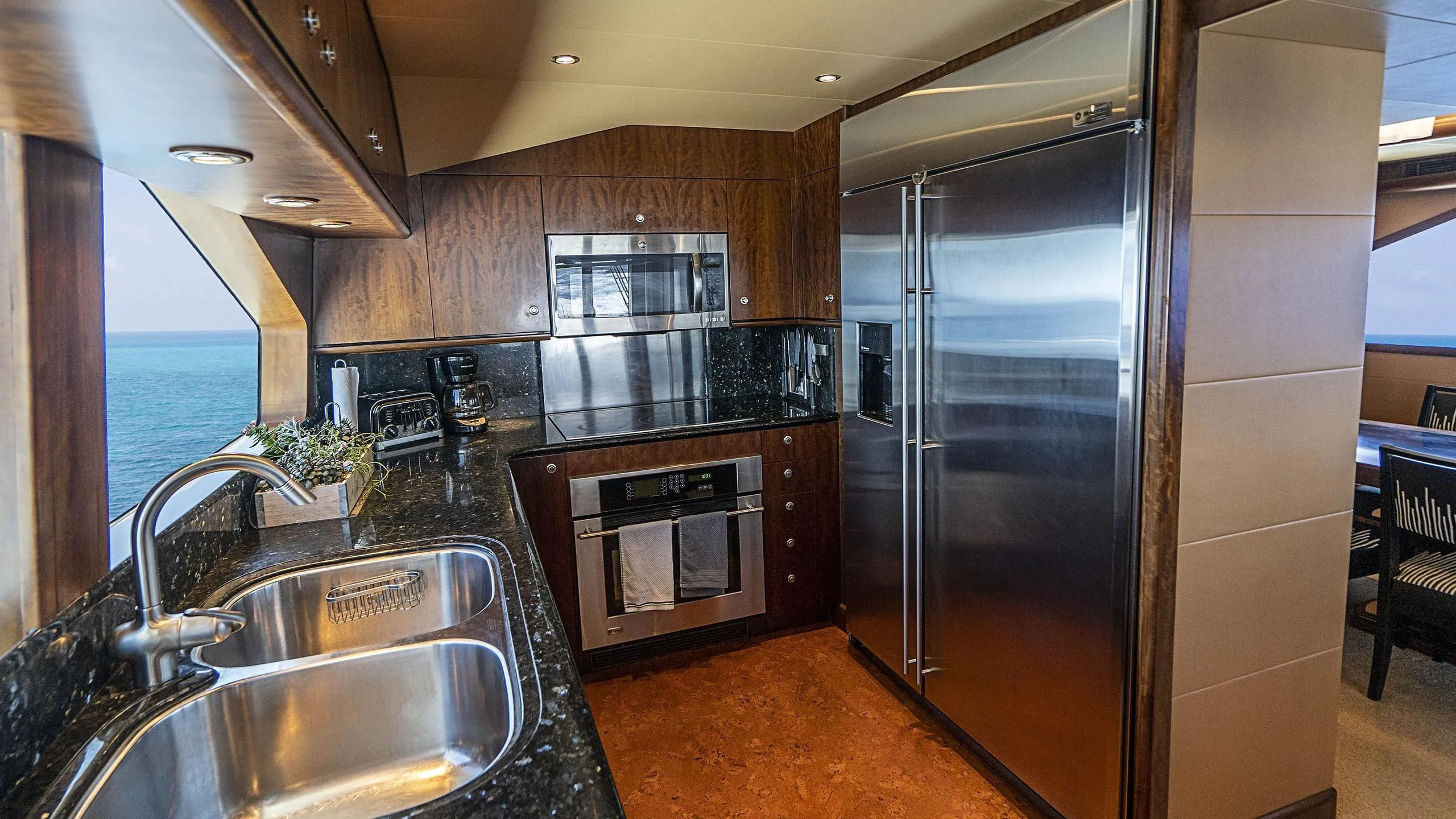 a kitchen with stainless steel appliances aboard GRAND LEGACY Yacht for Sale