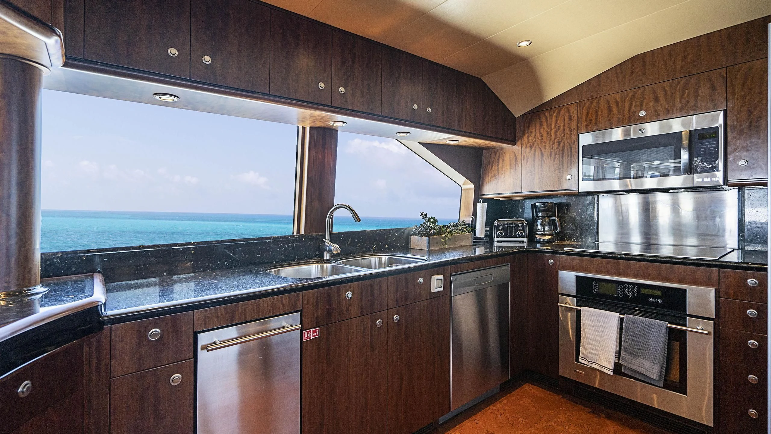 a kitchen with black cabinets aboard GRAND LEGACY Yacht for Sale