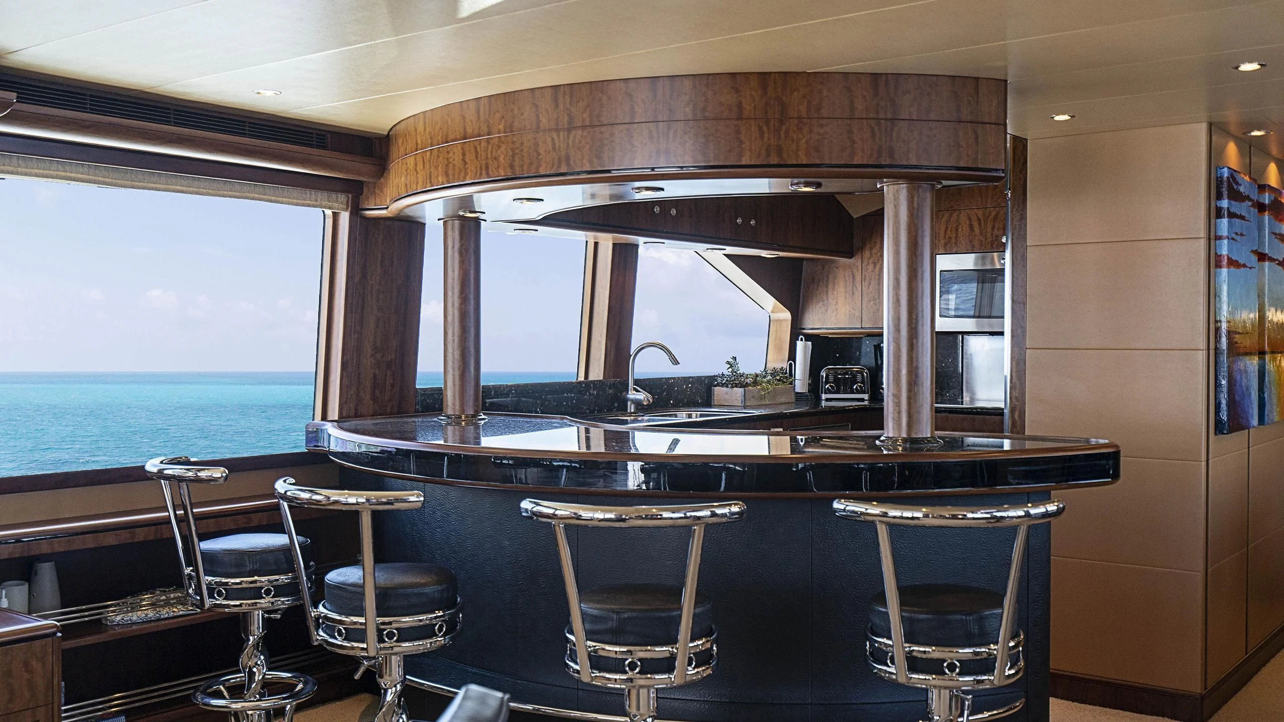 a bar with a table and chairs aboard GRAND LEGACY Yacht for Sale