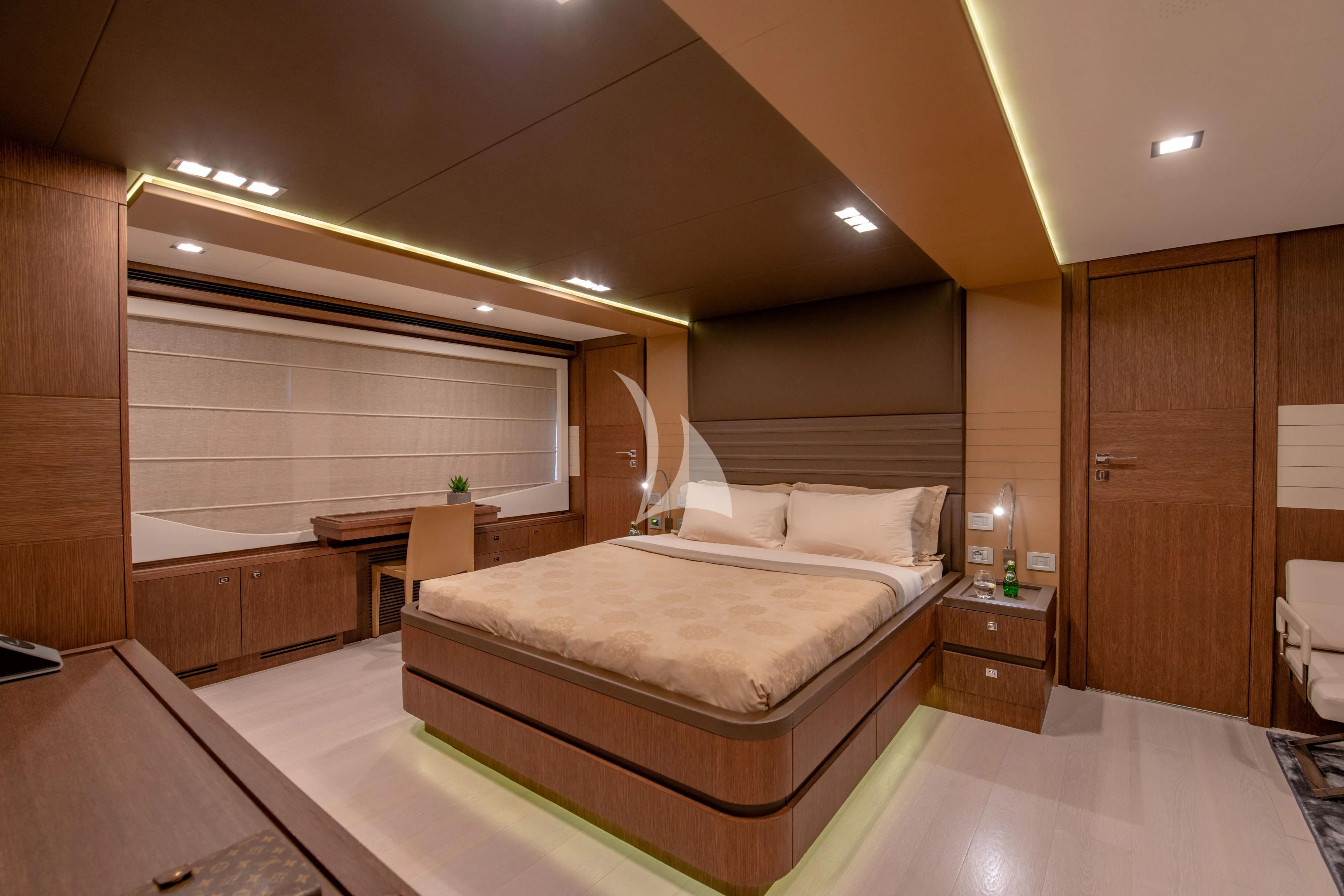 a large bedroom with a bed aboard INFINITAS Yacht for Charter