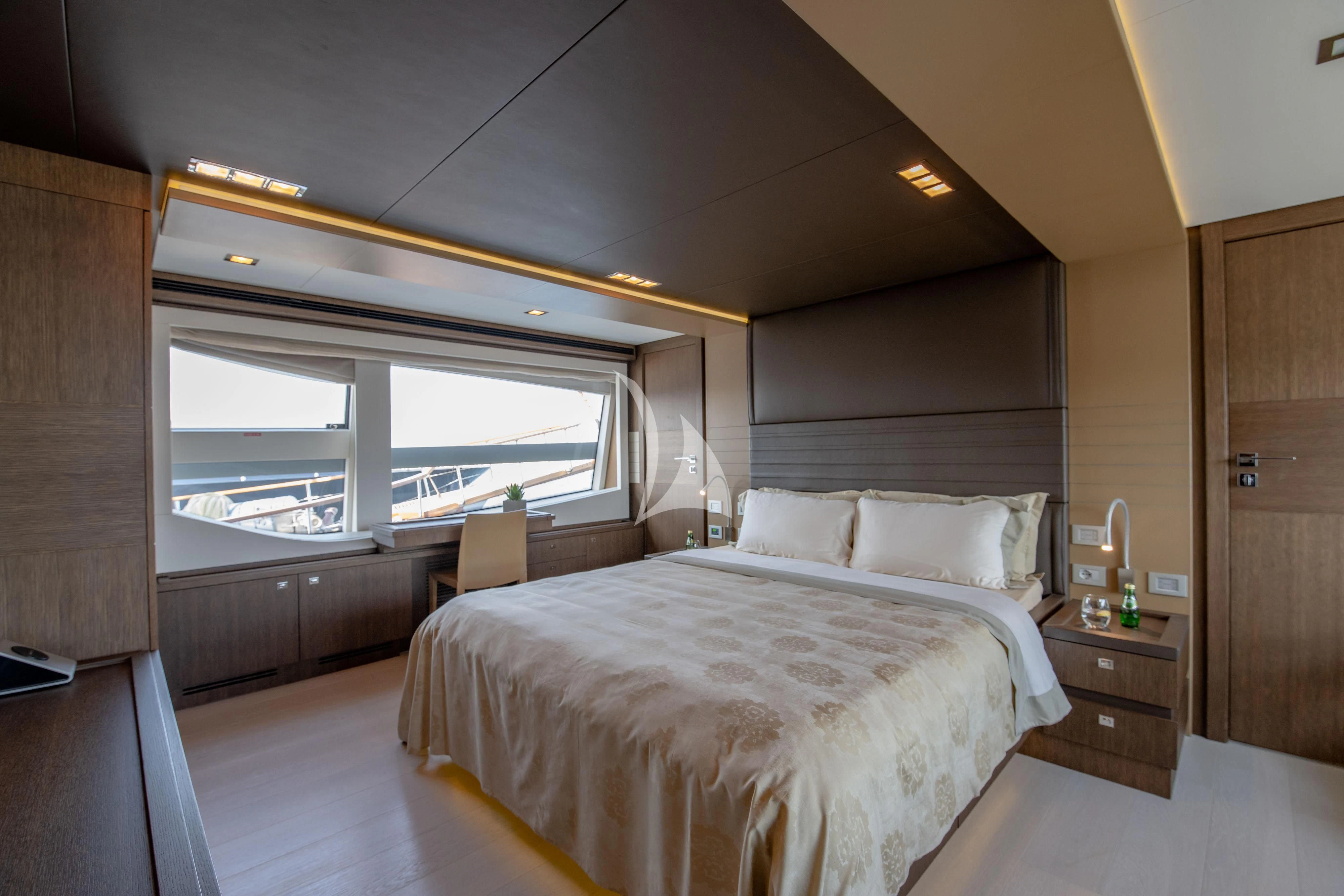 a bedroom with a large bed aboard INFINITAS Yacht for Charter