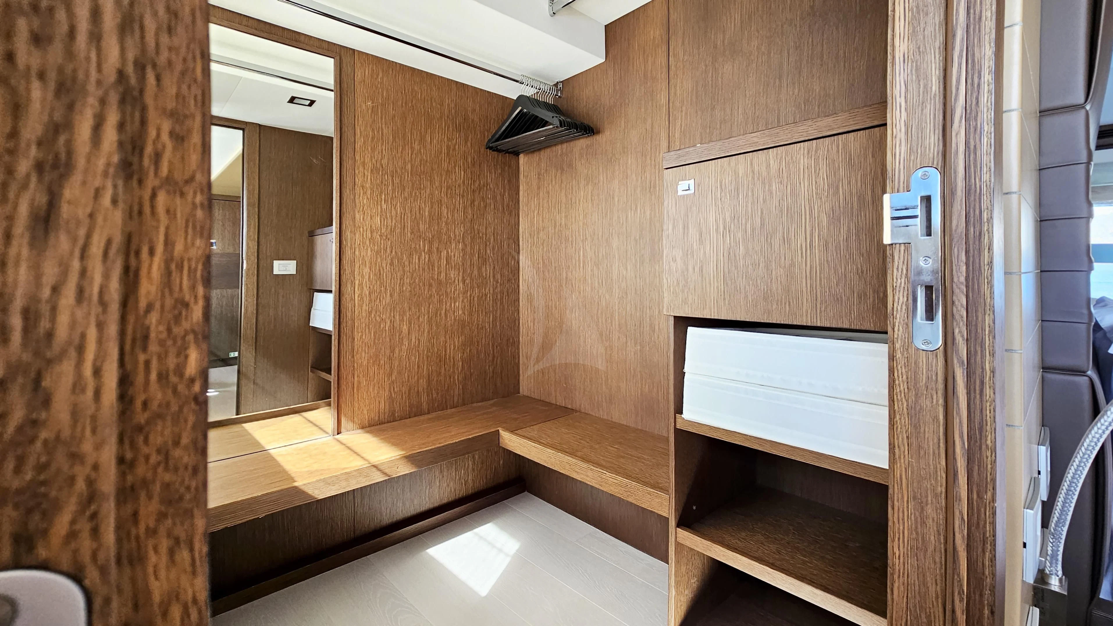 a room with wooden walls and a wood door aboard INFINITAS Yacht for Charter