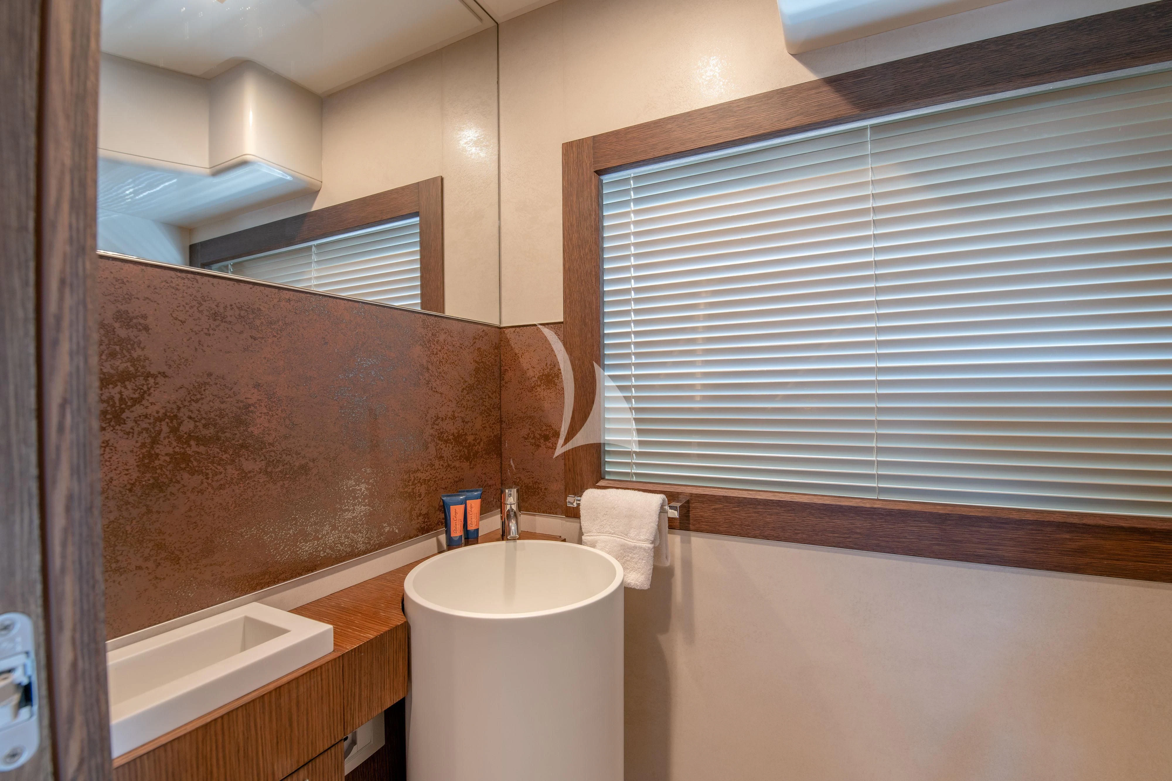 a bathroom with a sink and a mirror aboard INFINITAS Yacht for Charter