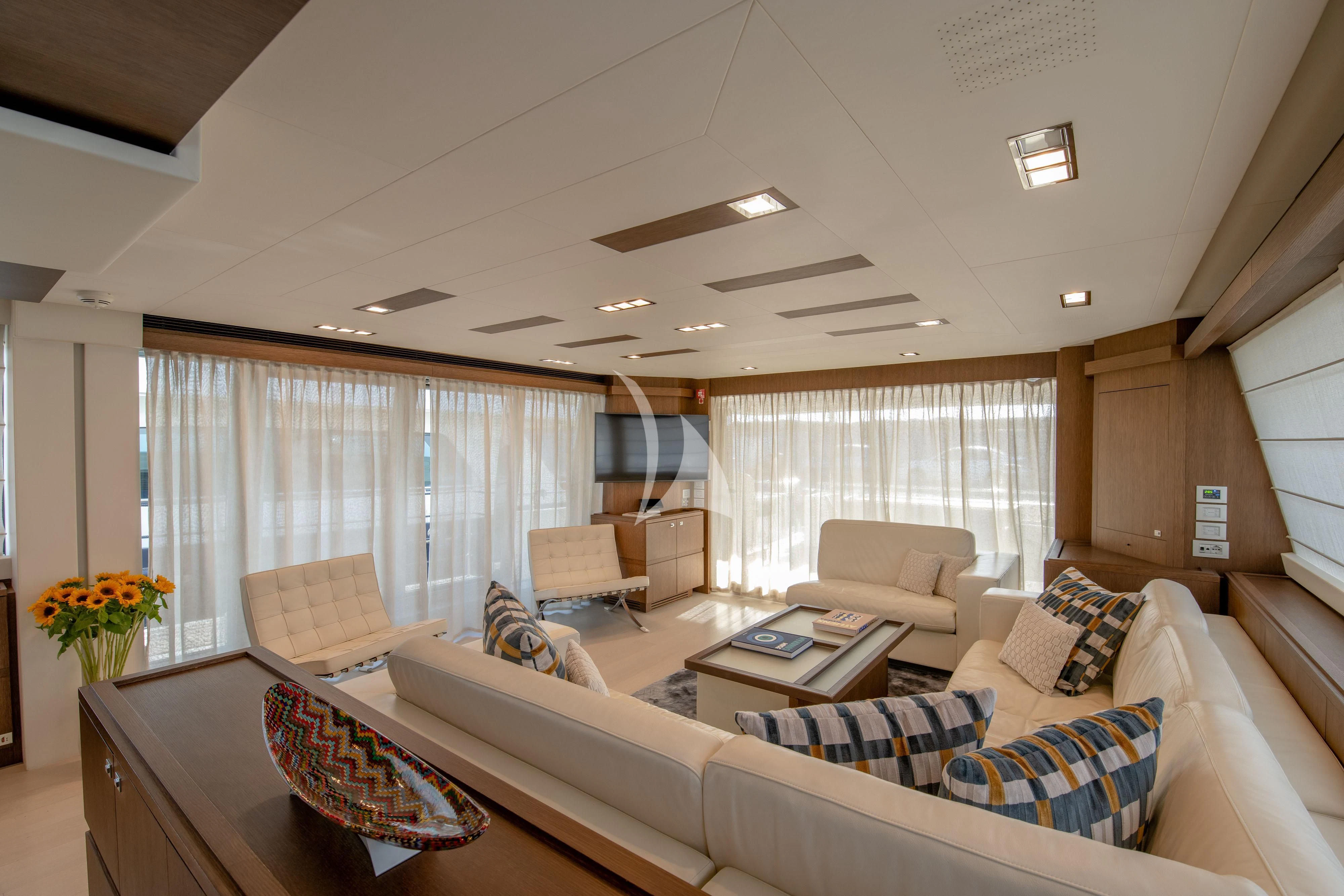 a living room with a couch and a table aboard INFINITAS Yacht for Charter