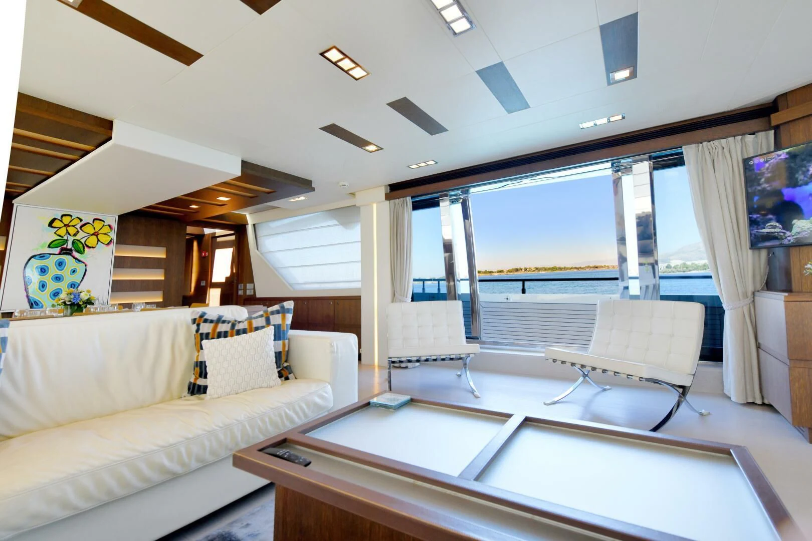 a room with a couch and a table aboard INFINITAS Yacht for Charter