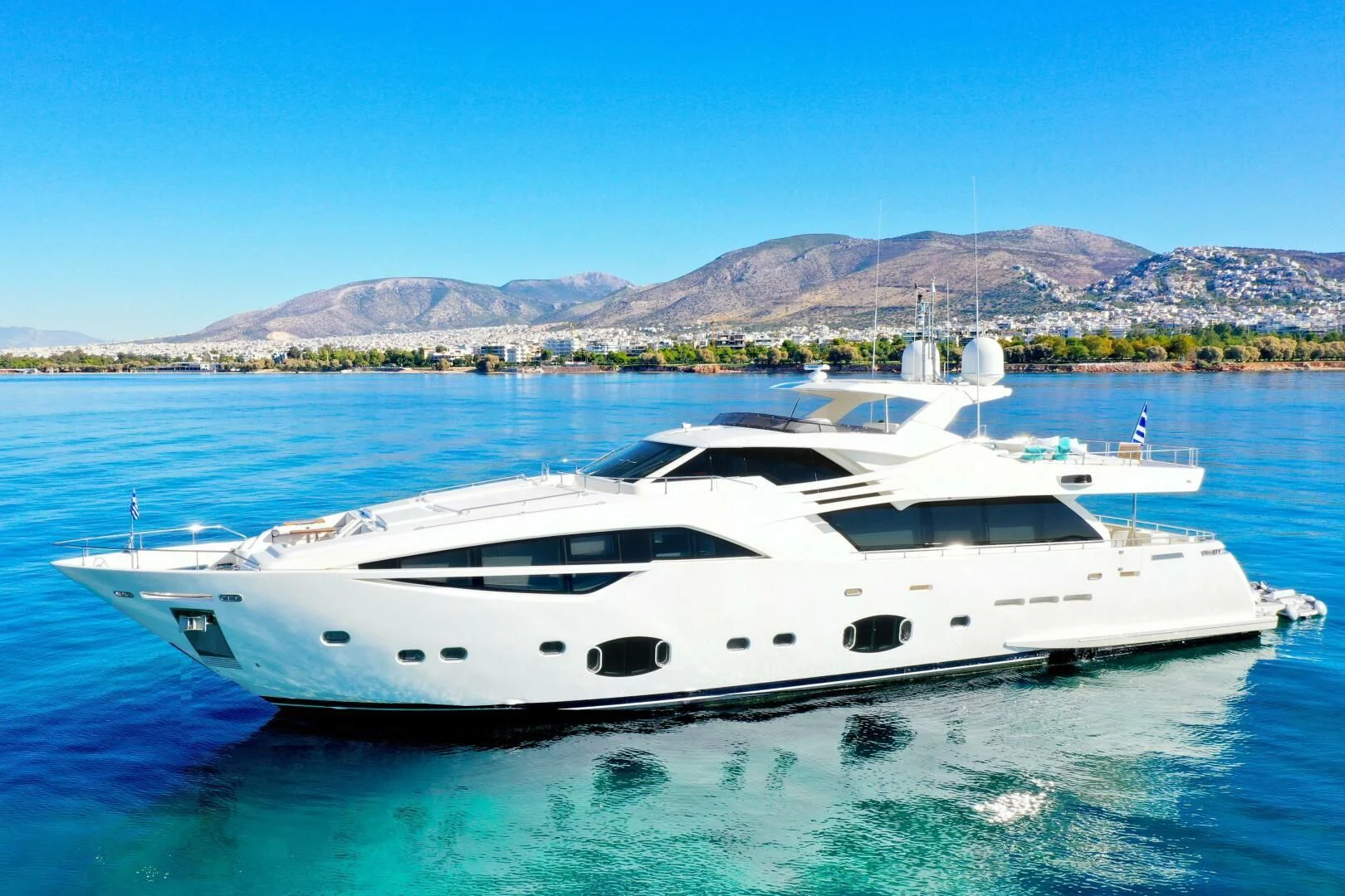 a white yacht in the water aboard INFINITAS Yacht for Charter