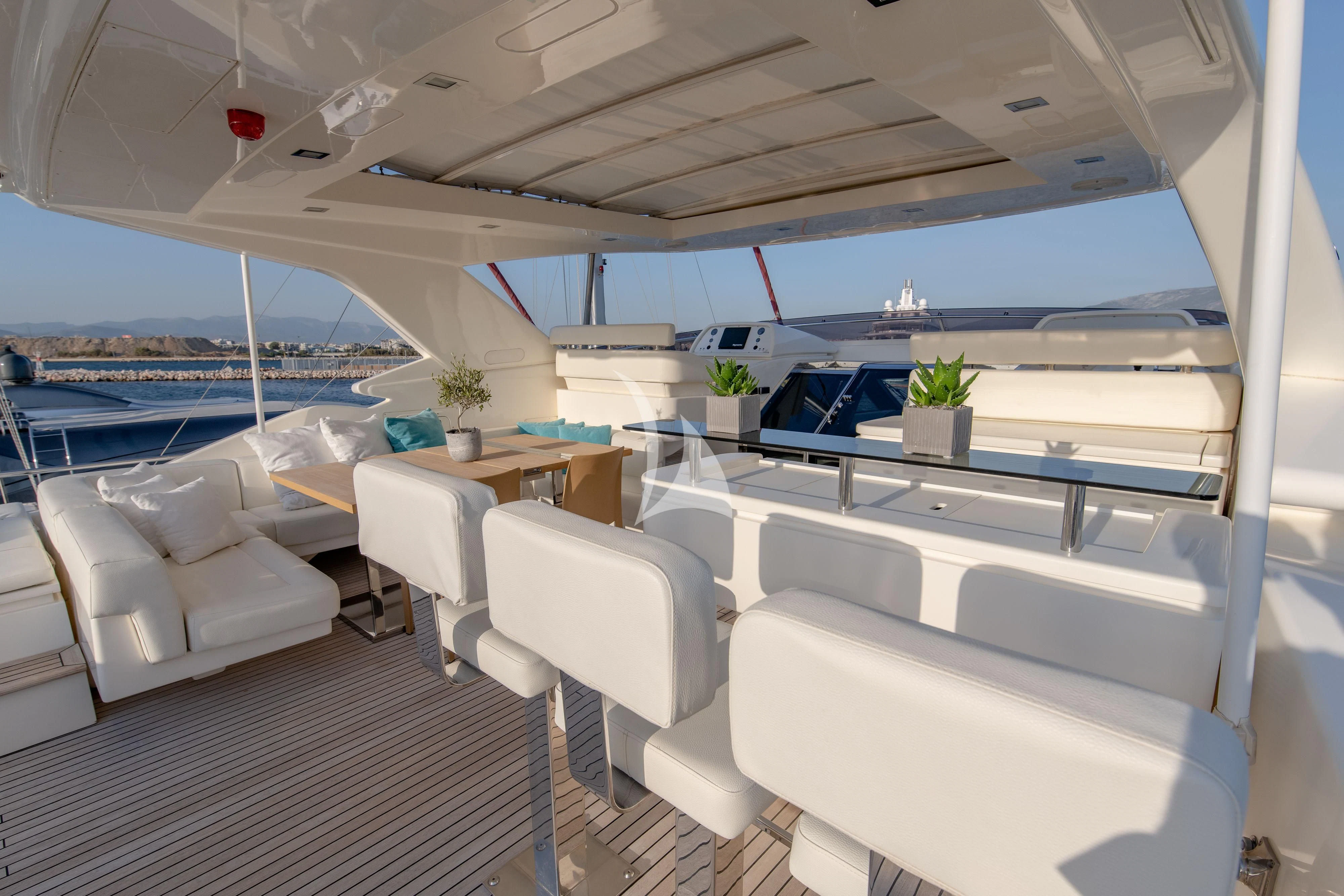 a room with a couch and a table and chairs aboard INFINITAS Yacht for Charter