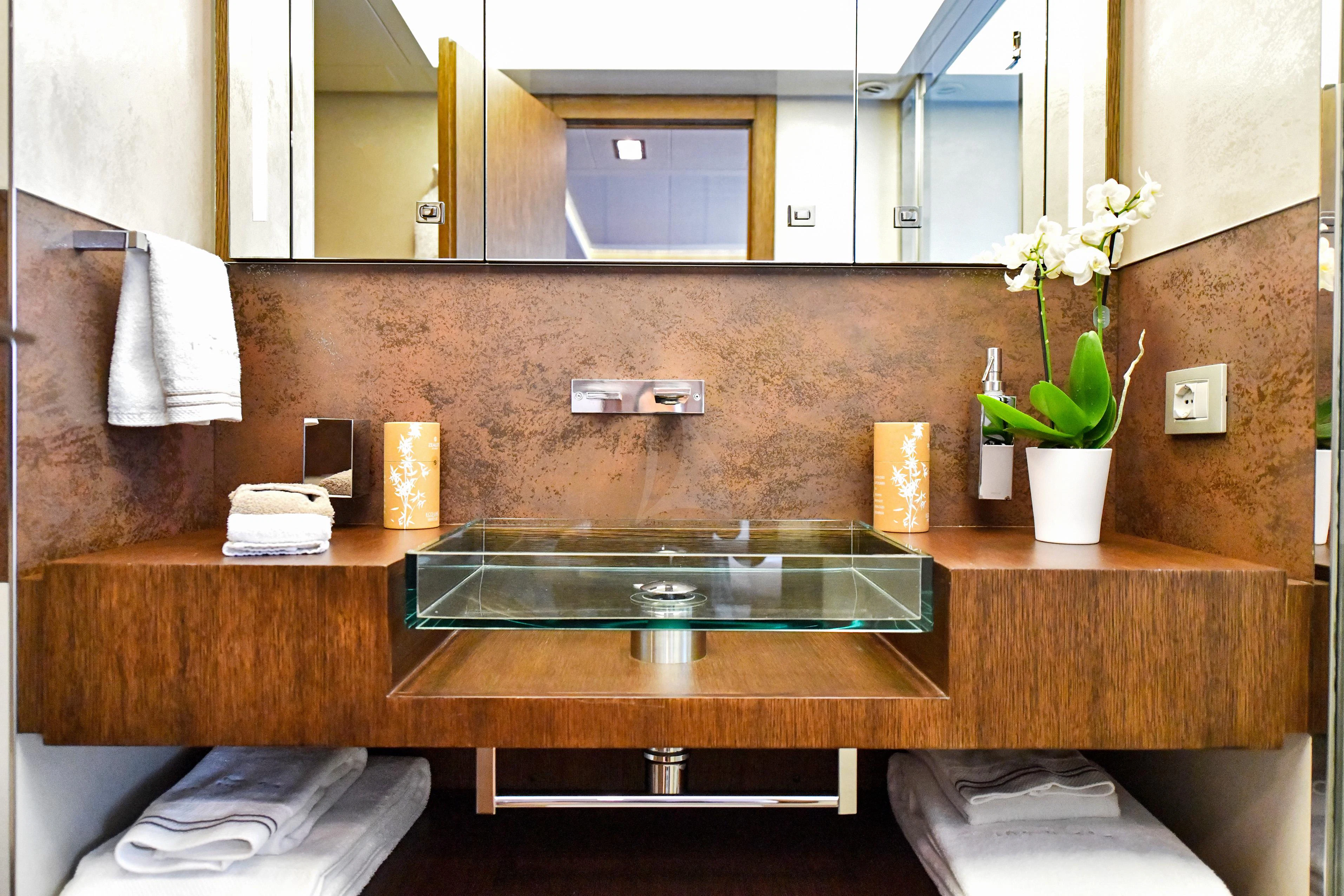 a bathroom with a sink and a mirror aboard INFINITAS Yacht for Charter