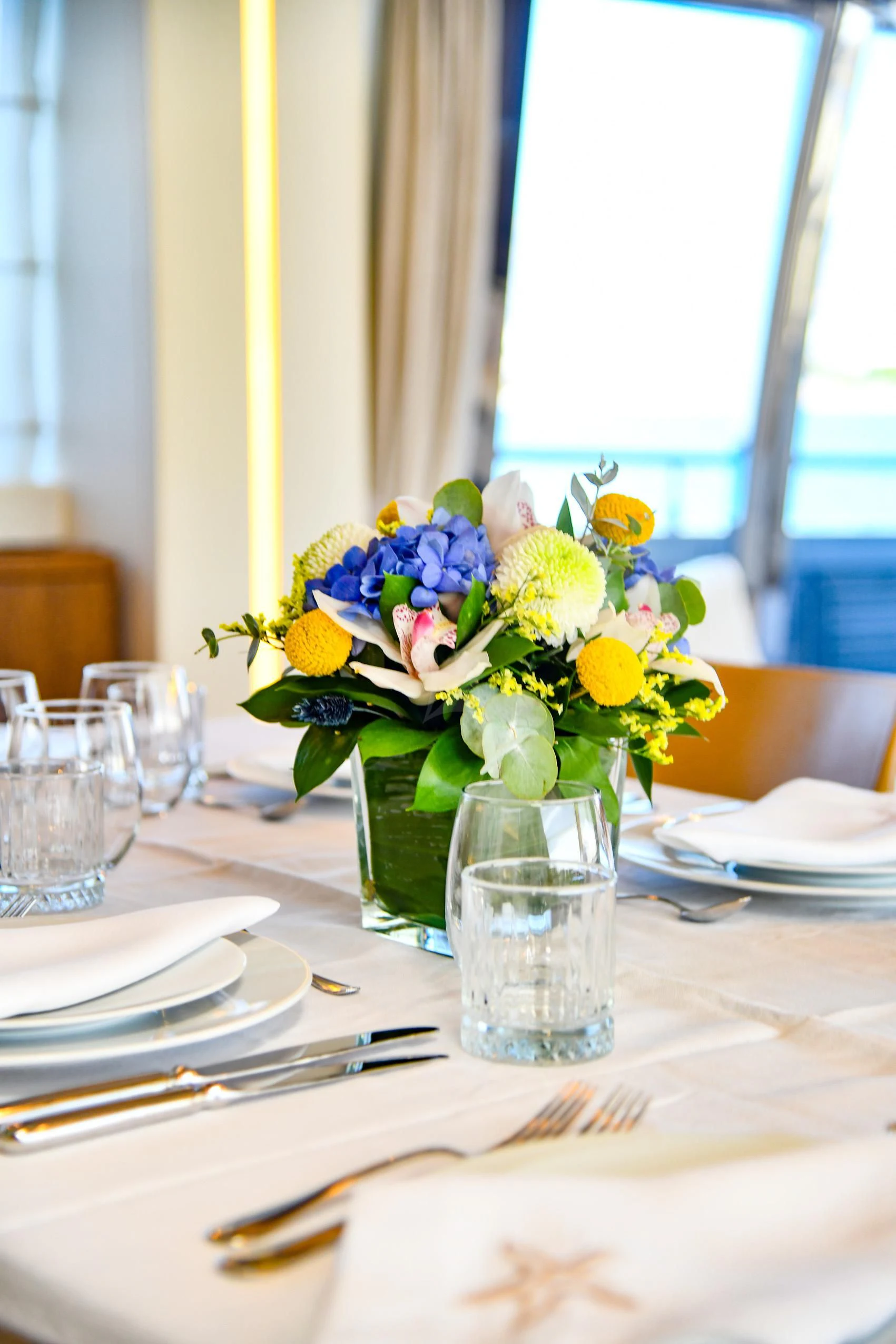 a vase of flowers sits on a table aboard INFINITAS Yacht for Charter