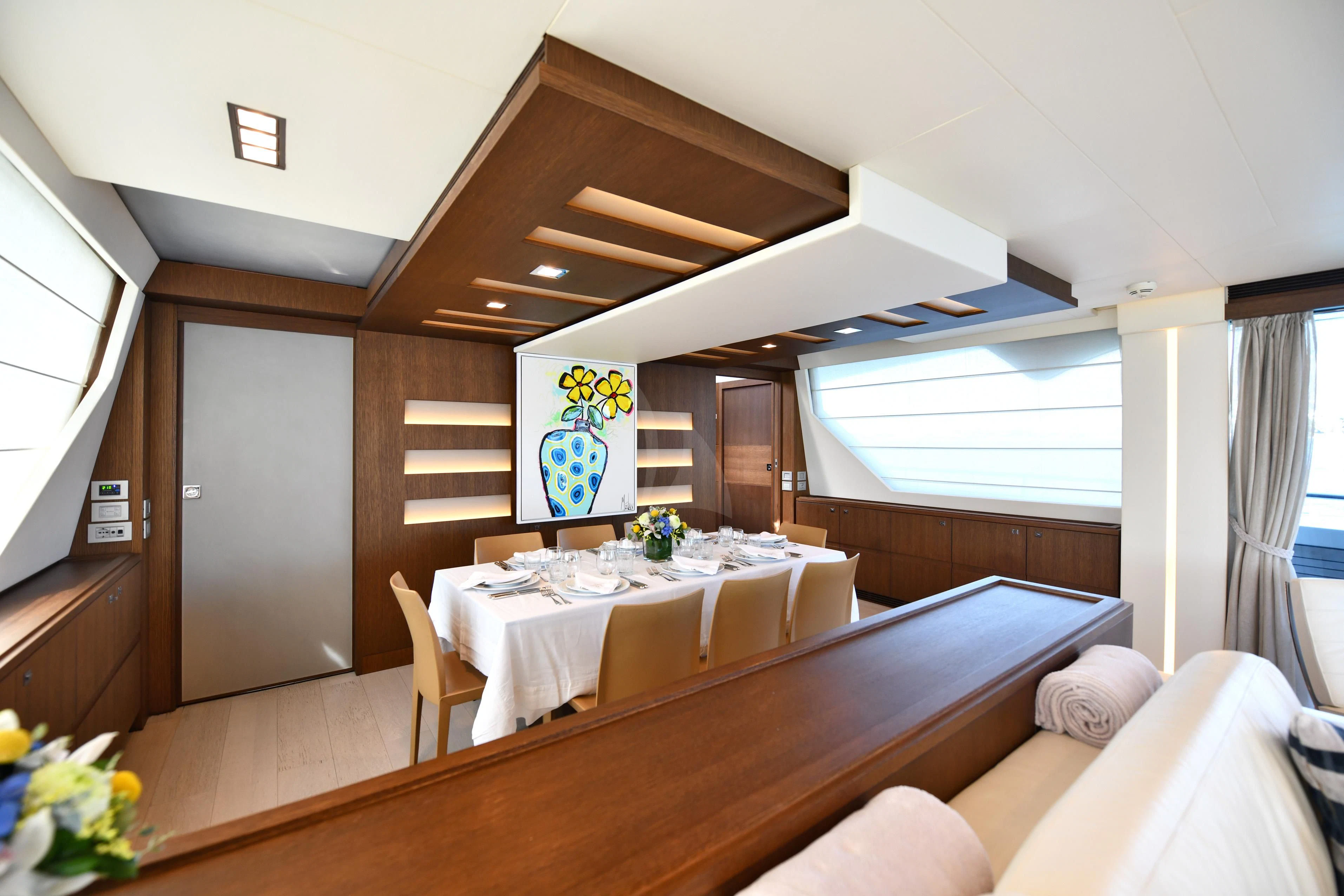 a room with a table and chairs aboard INFINITAS Yacht for Charter