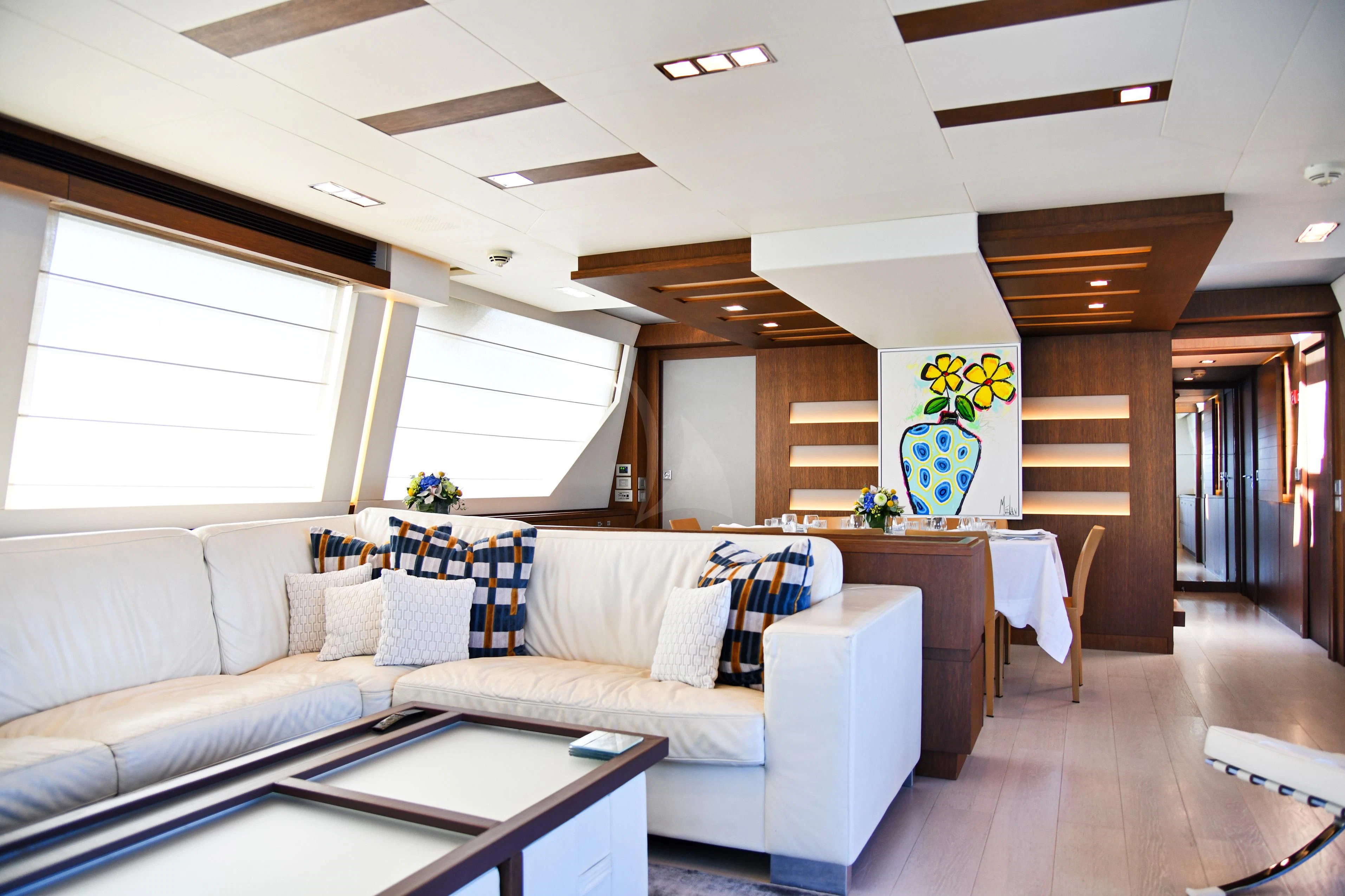 a living room with a couch and a table aboard INFINITAS Yacht for Charter