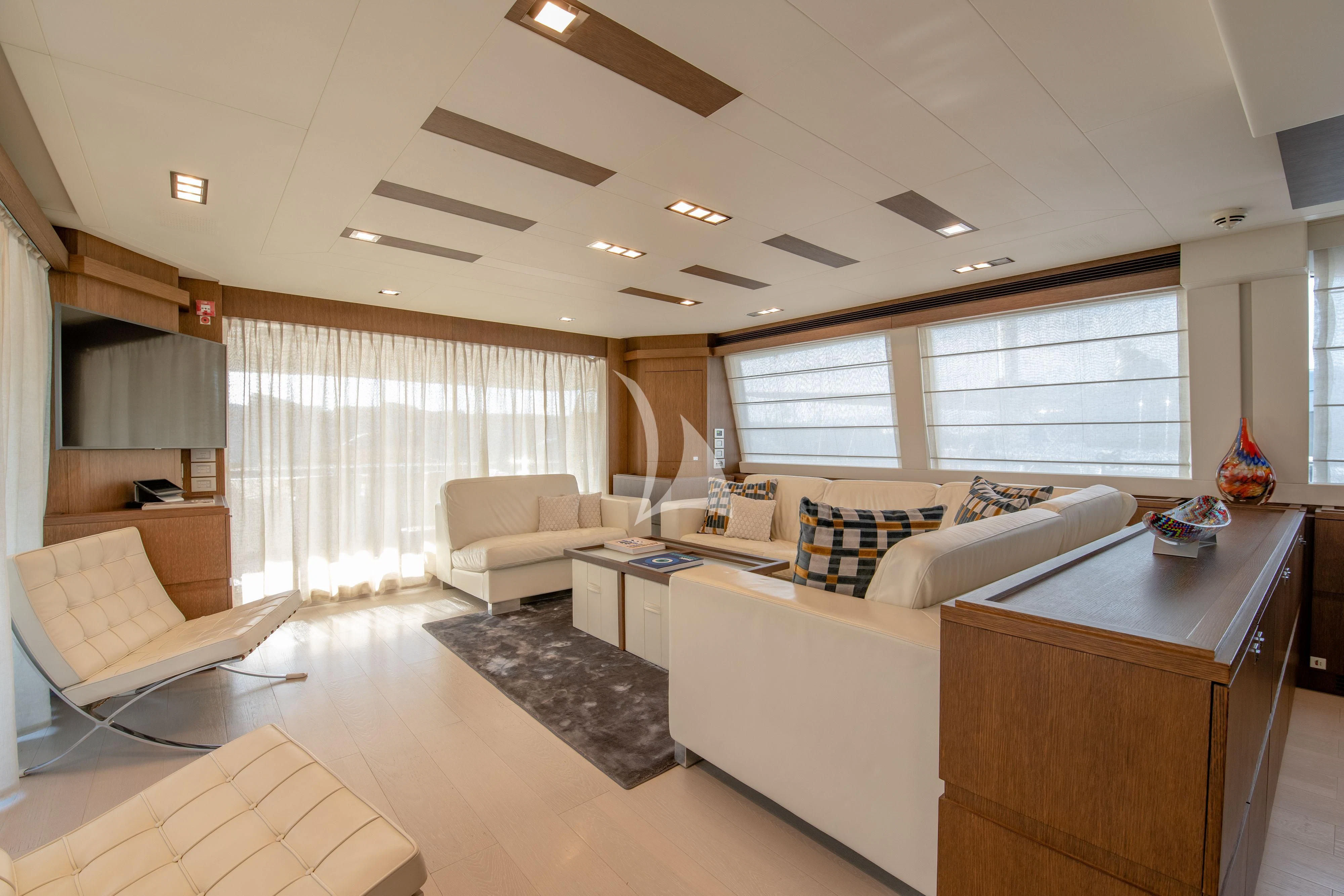 a living room with a couch and a fan aboard INFINITAS Yacht for Charter