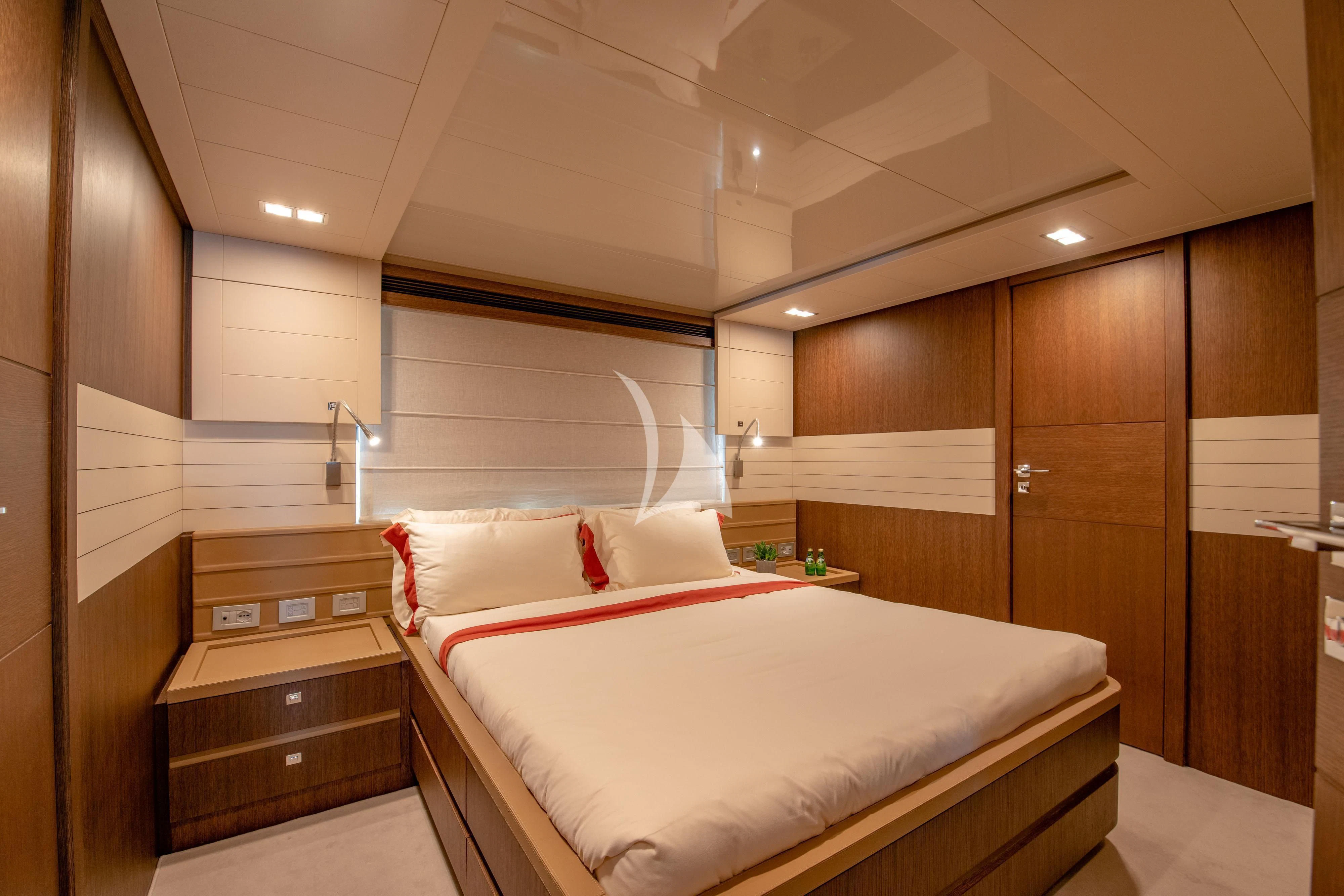a bedroom with a bed and a closet aboard INFINITAS Yacht for Charter