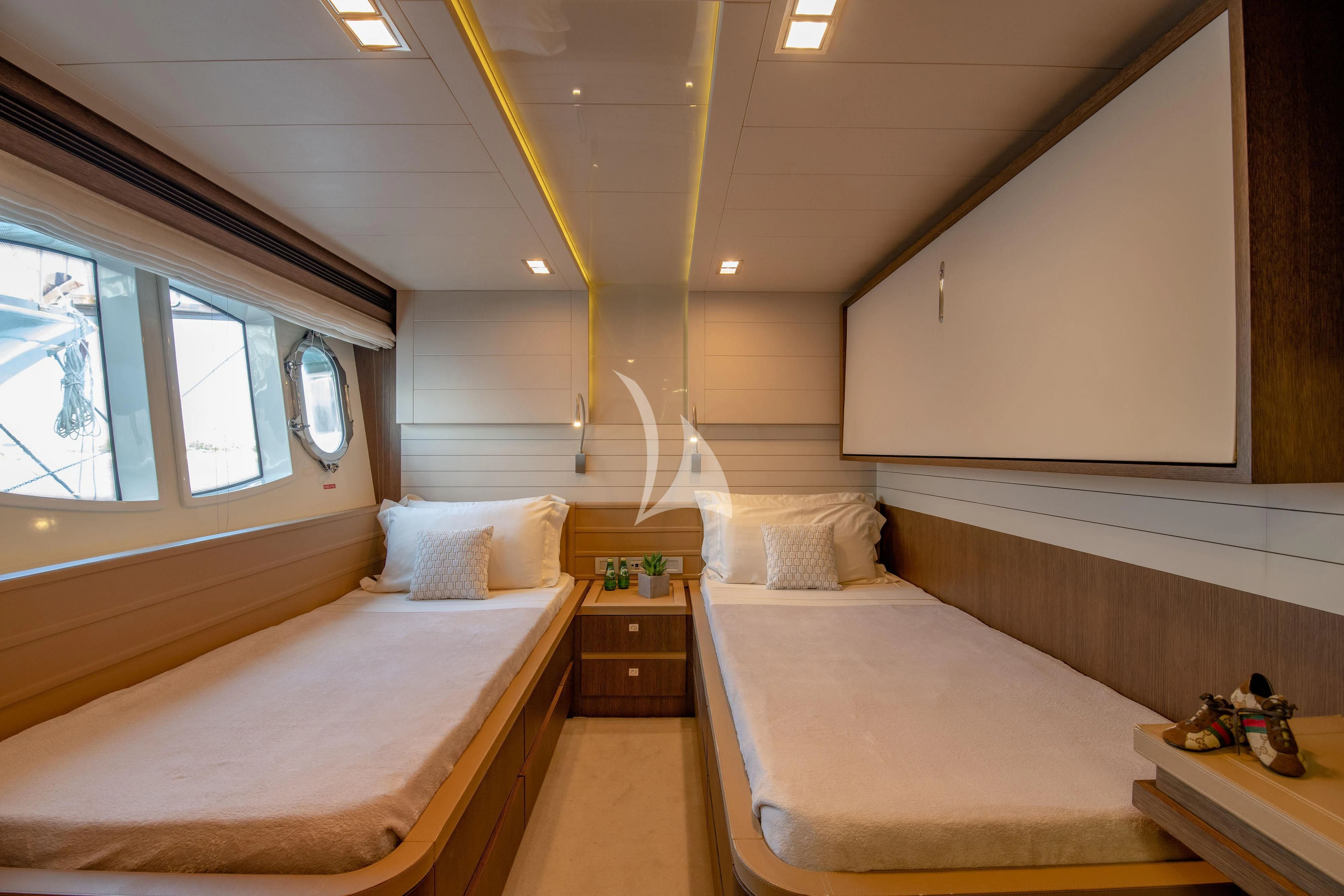 a room with two beds aboard INFINITAS Yacht for Charter