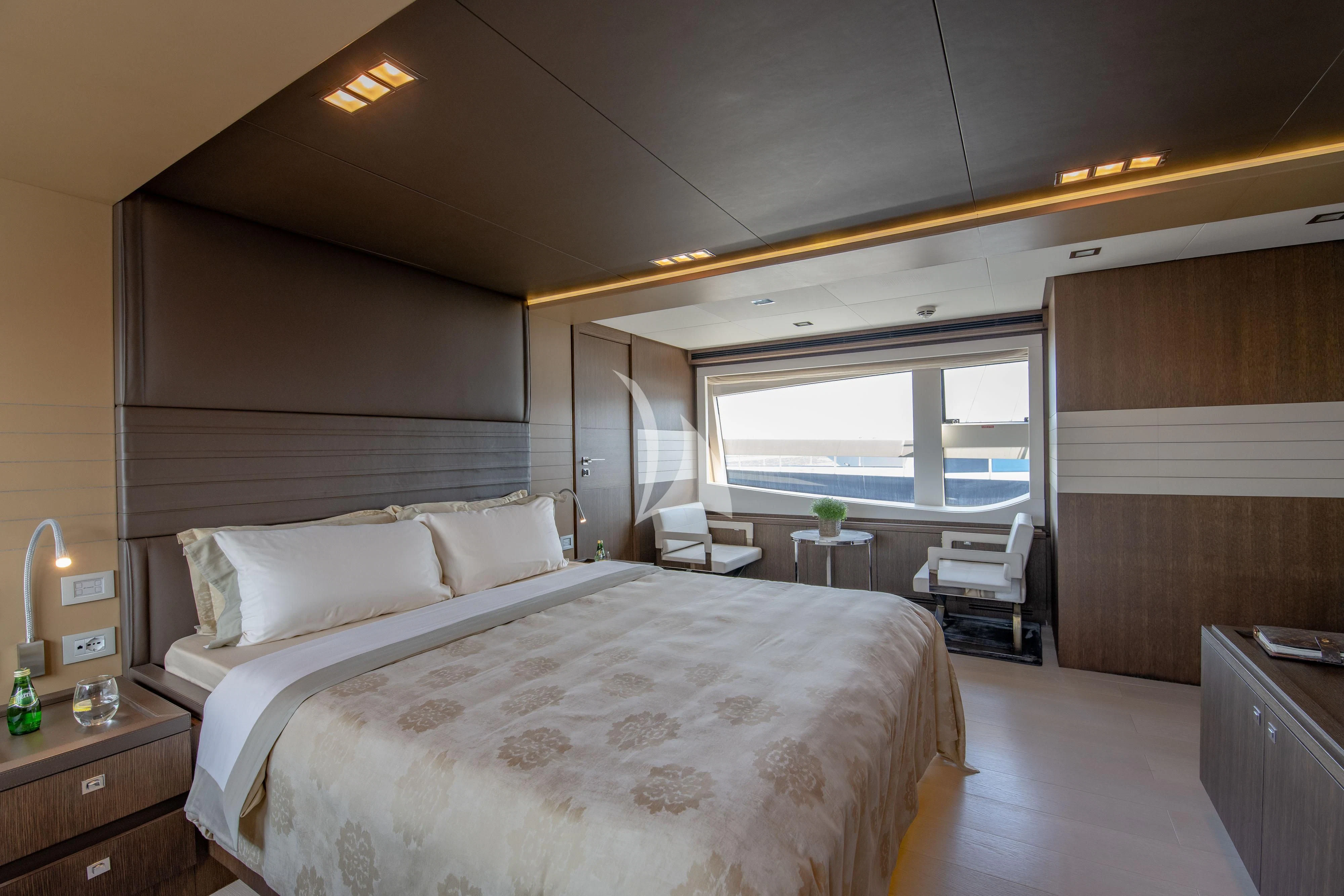 a room with a bed and a window aboard INFINITAS Yacht for Charter
