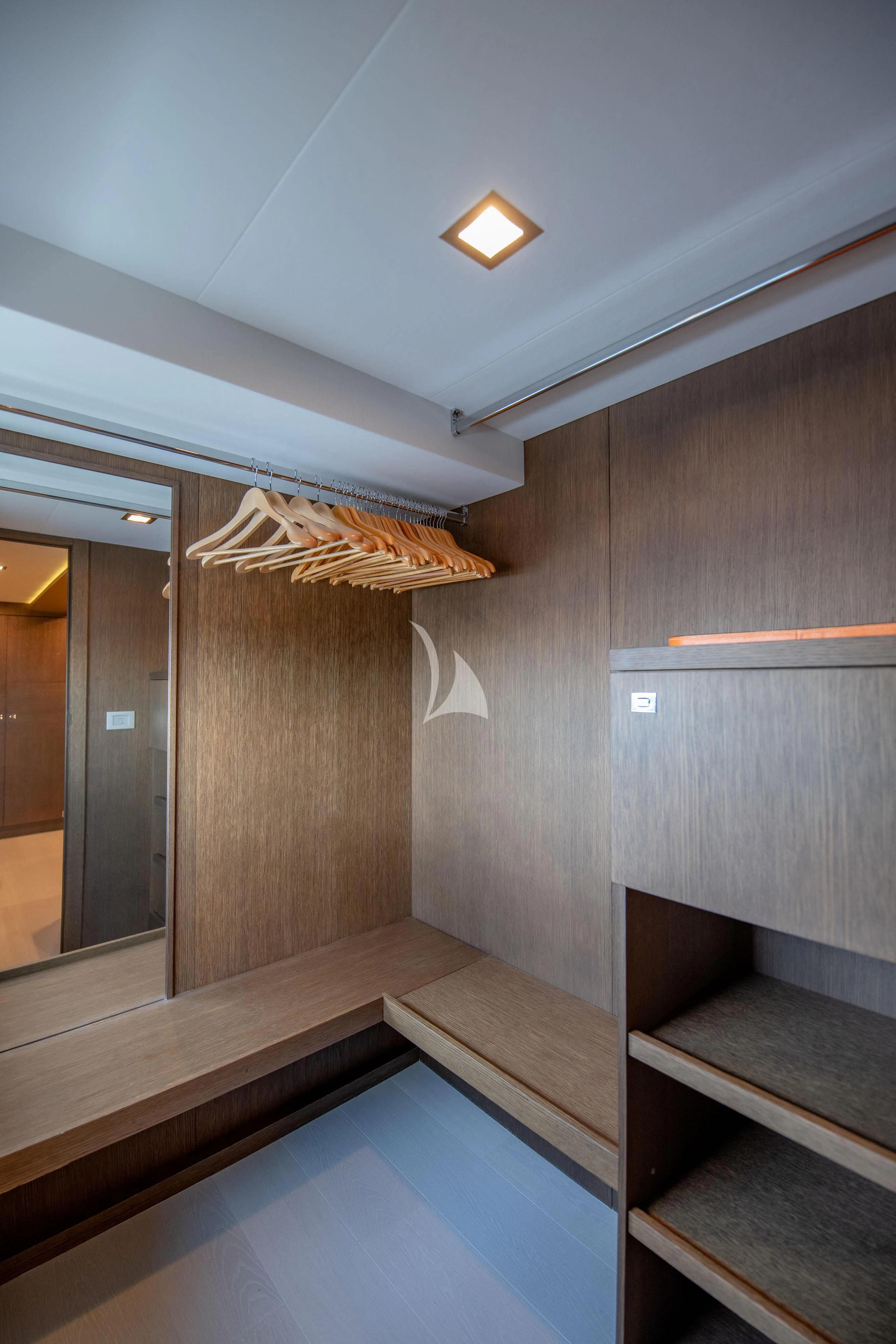 a room with wooden floors and a wood wall aboard INFINITAS Yacht for Charter