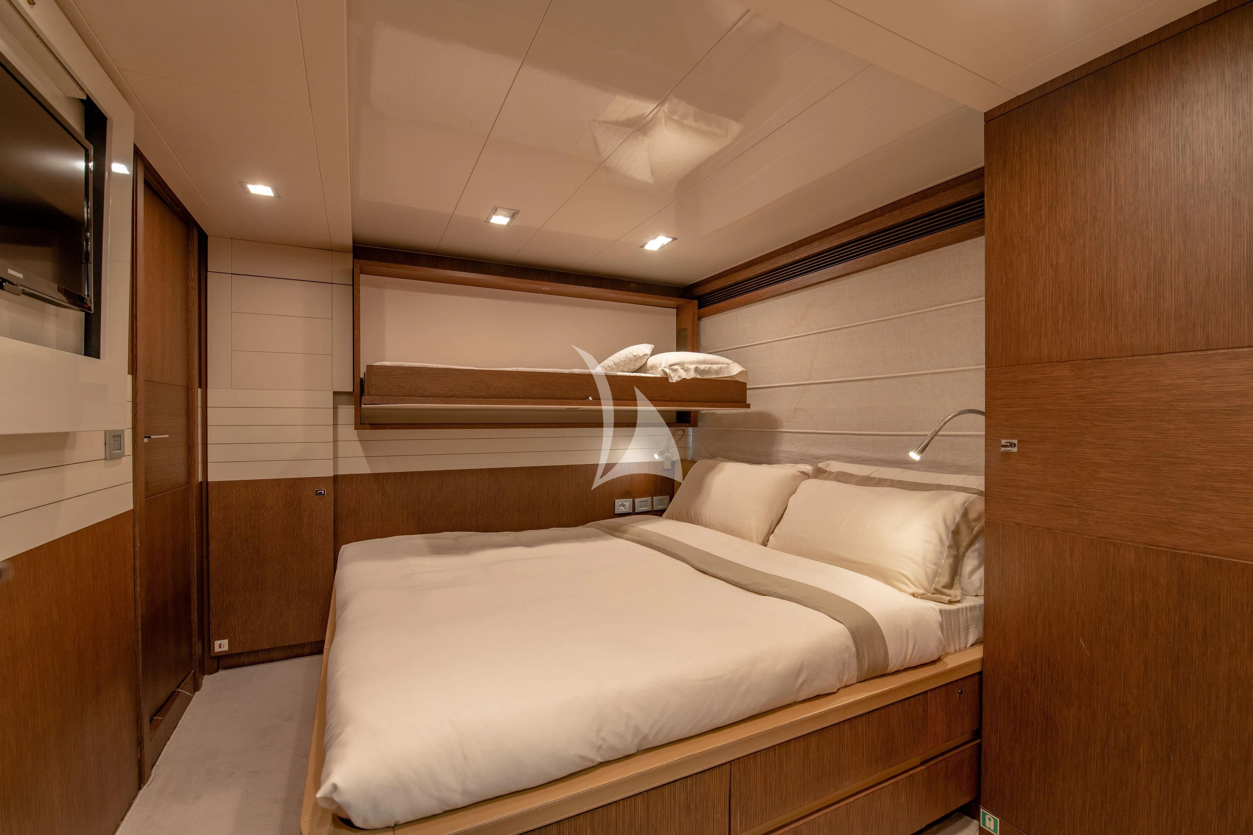 a room with a bed and a mirror aboard INFINITAS Yacht for Charter