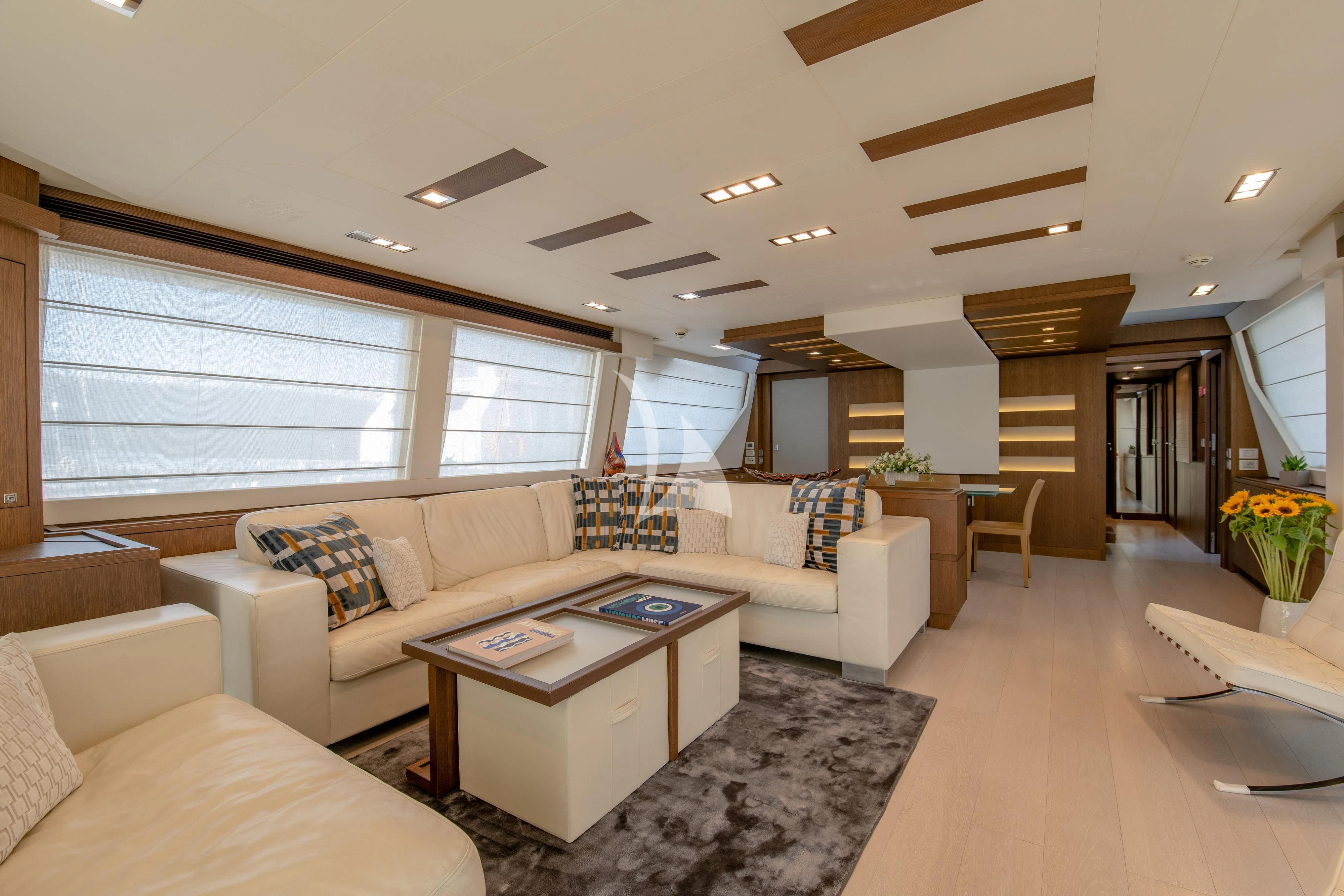 a living room with a large window aboard INFINITAS Yacht for Charter