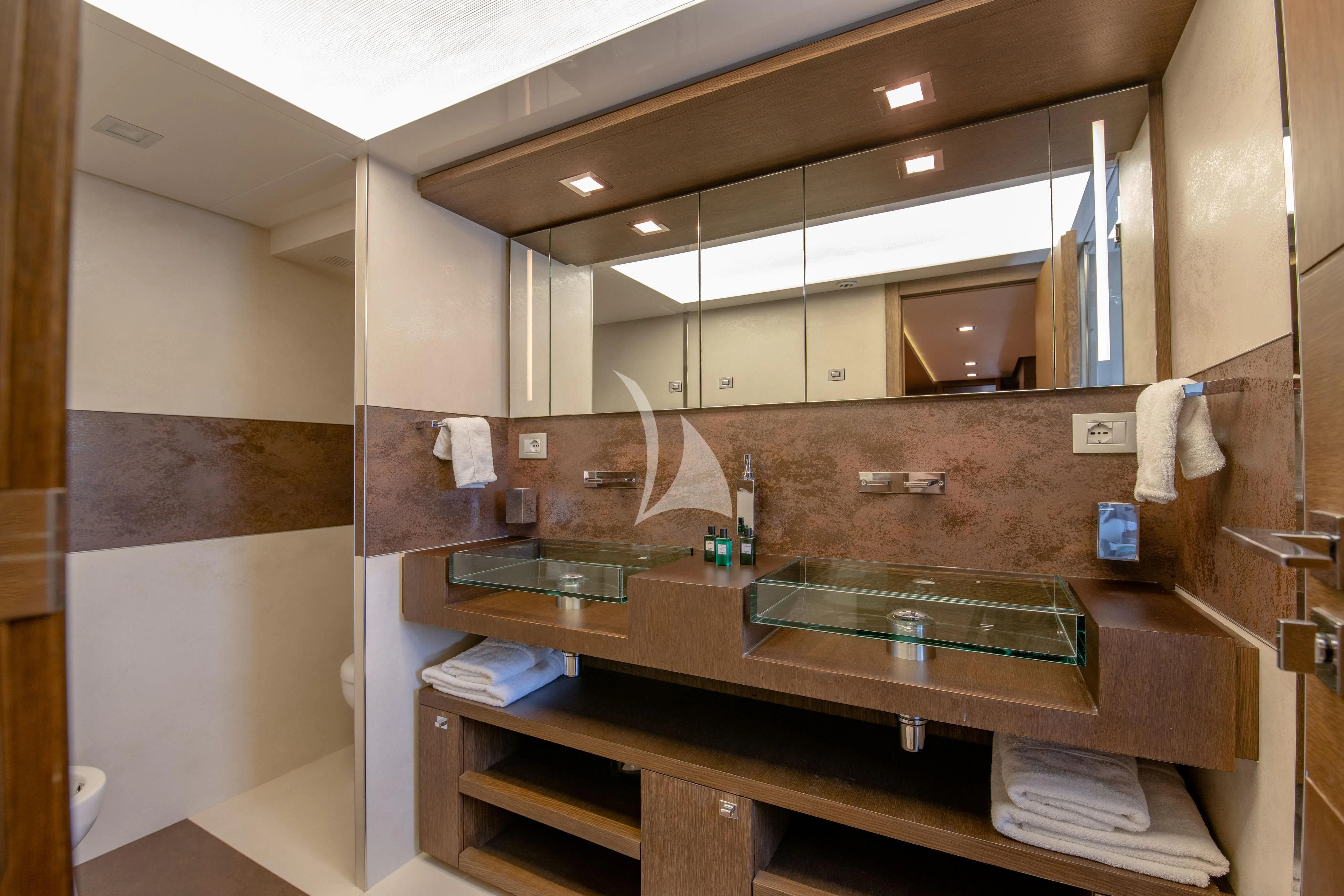 a bathroom with a sink and a mirror aboard INFINITAS Yacht for Charter