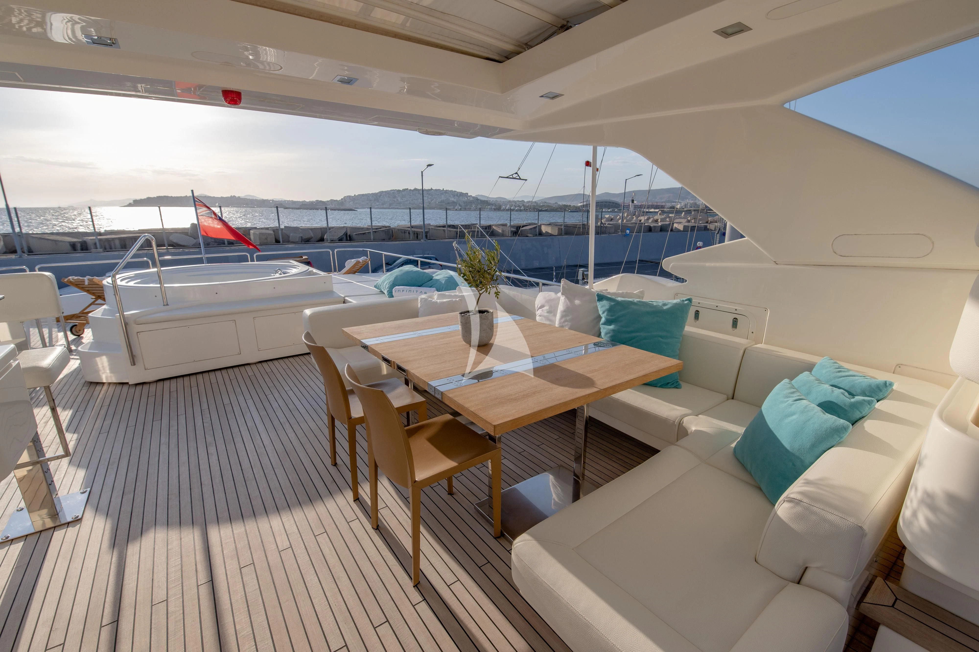 a boat with a table and chairs aboard INFINITAS Yacht for Charter