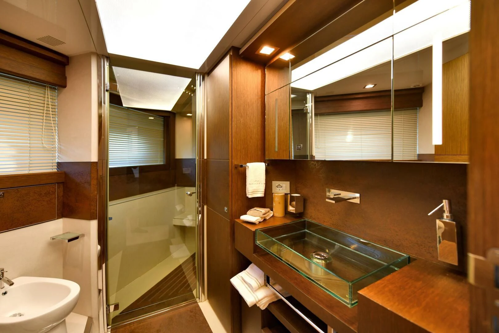 a bathroom with a glass shower aboard INFINITAS Yacht for Charter
