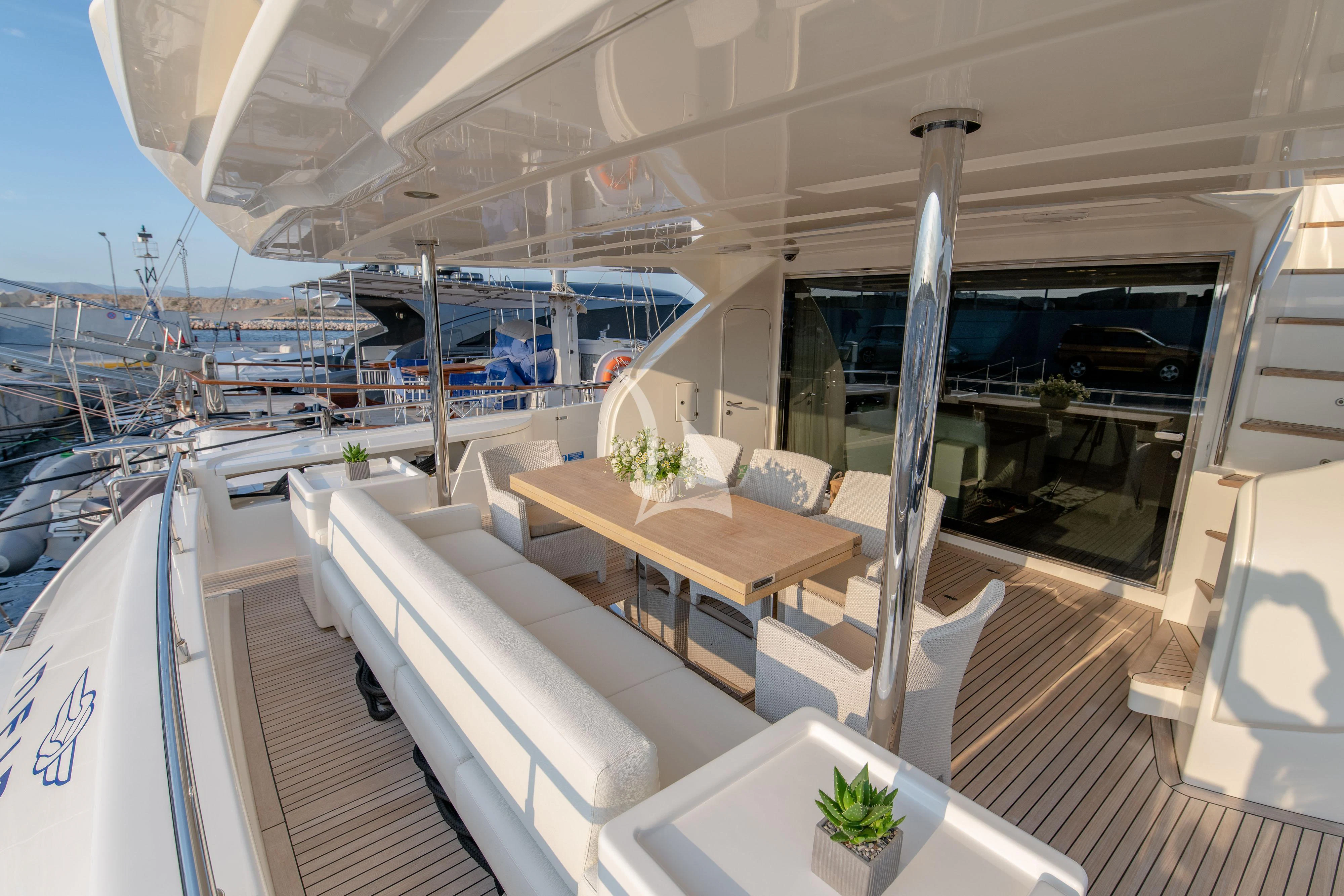 a room with a table and chairs aboard INFINITAS Yacht for Charter