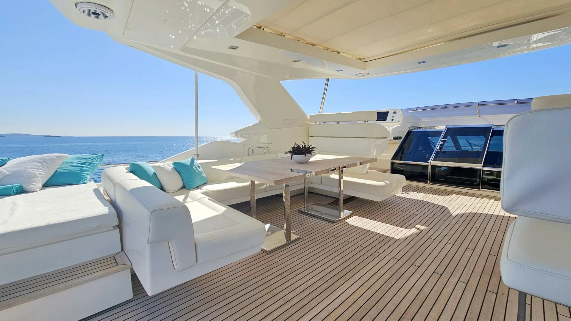 a room with a bed and a table aboard INFINITAS Yacht for Charter