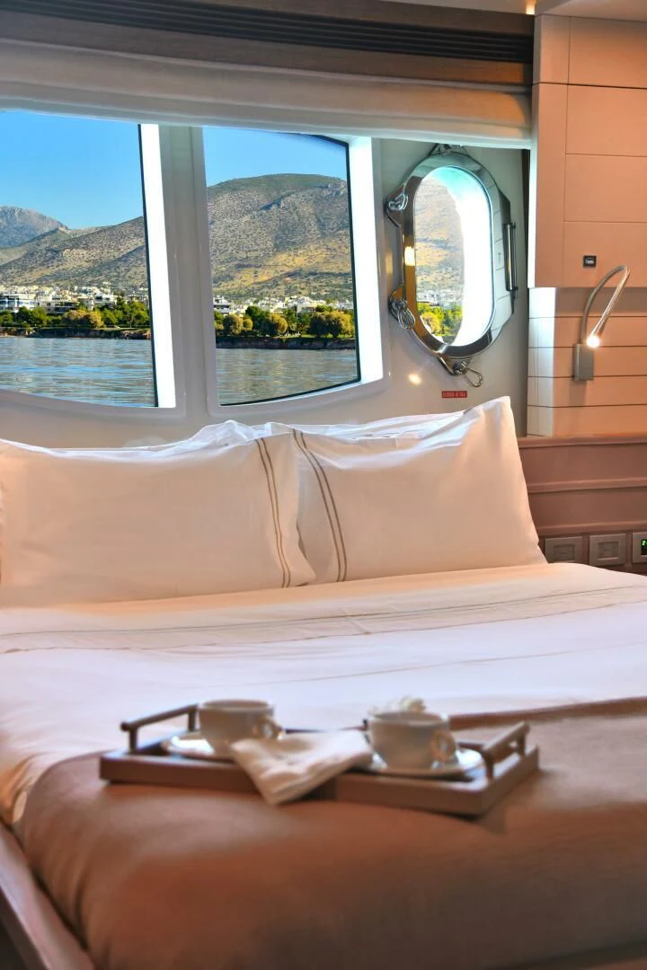 a bed with a mirror above it aboard INFINITAS Yacht for Charter