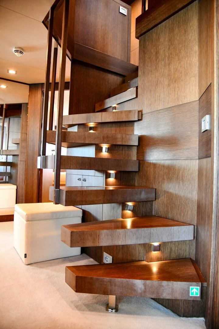 a room with wooden stairs aboard INFINITAS Yacht for Charter