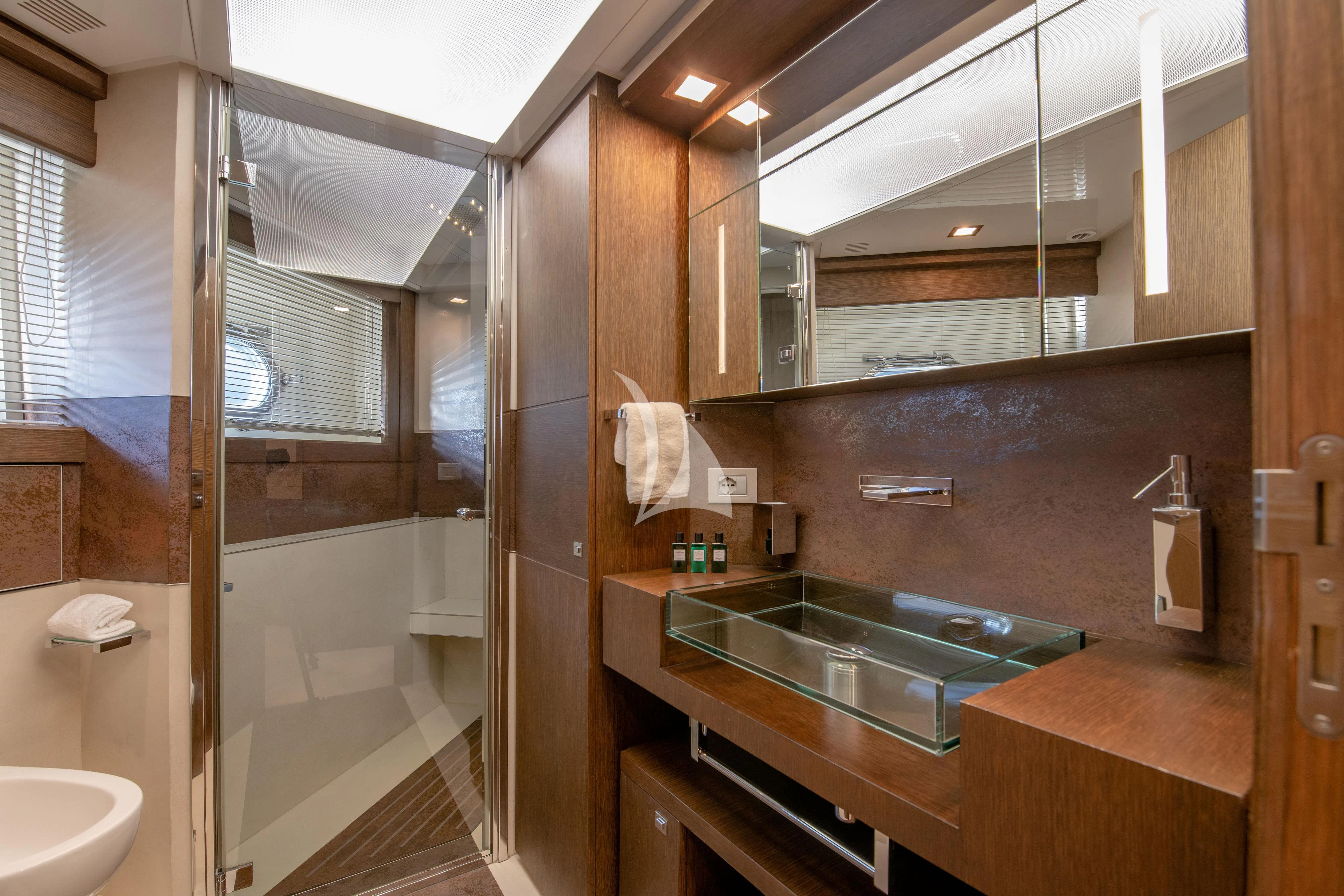 a bathroom with a glass shower aboard INFINITAS Yacht for Charter
