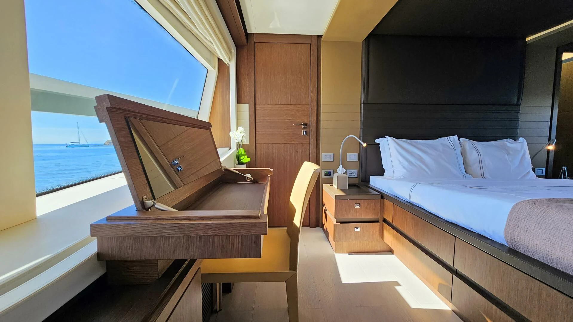 a room with a bed and a piano aboard INFINITAS Yacht for Charter