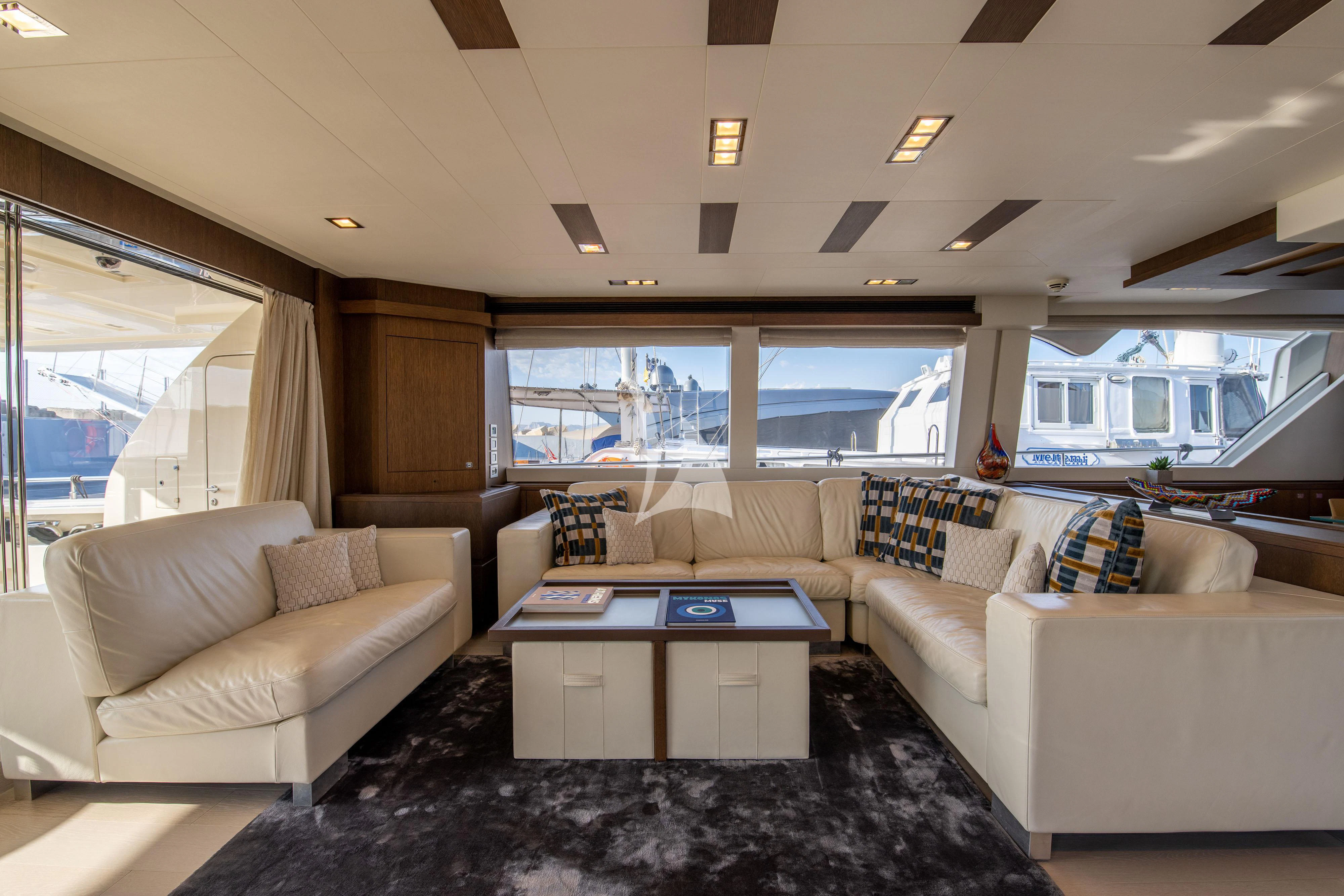 a living room with a large window aboard INFINITAS Yacht for Charter