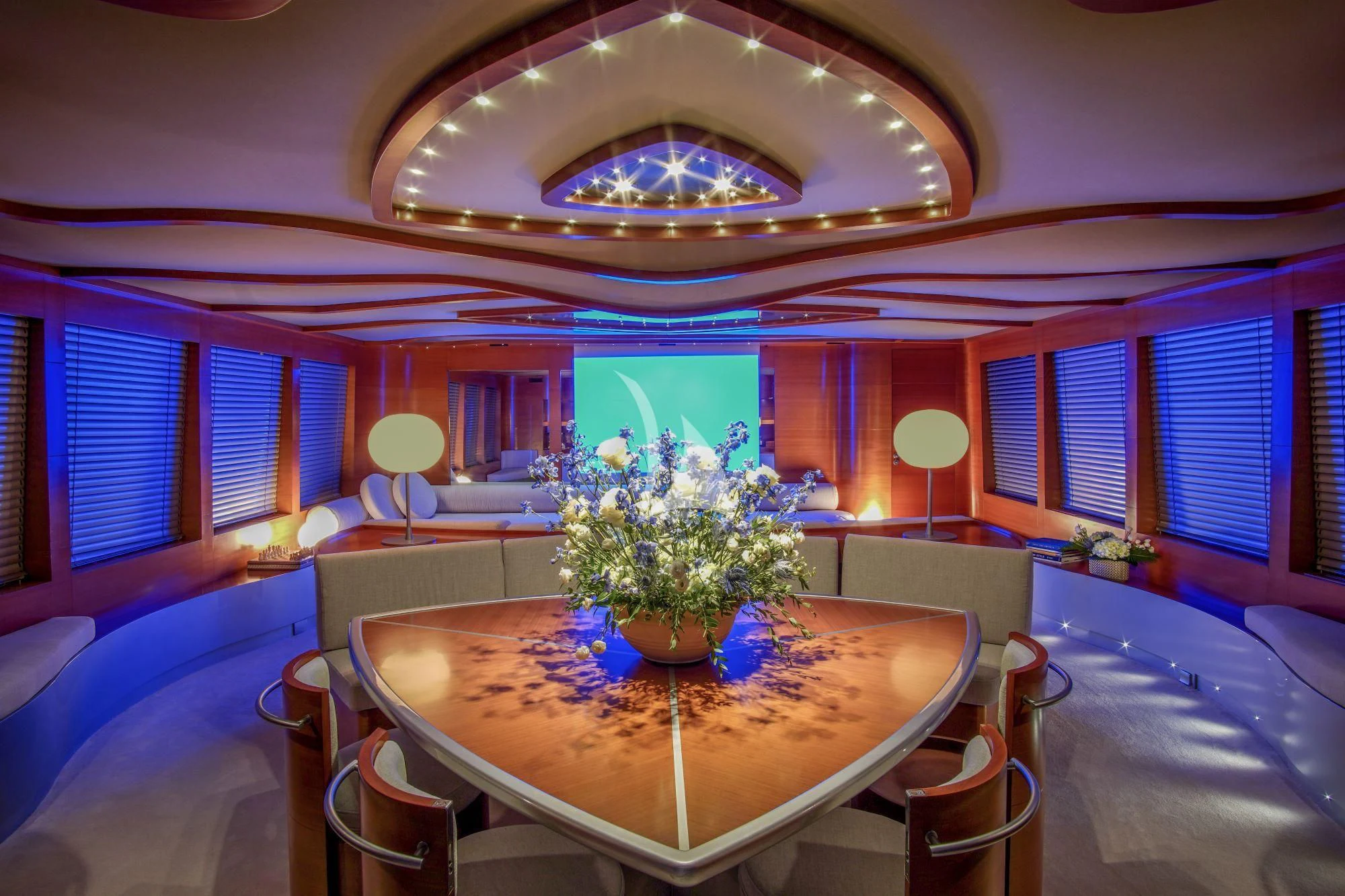 a large room with a table and chairs aboard SATORI Yacht for Sale