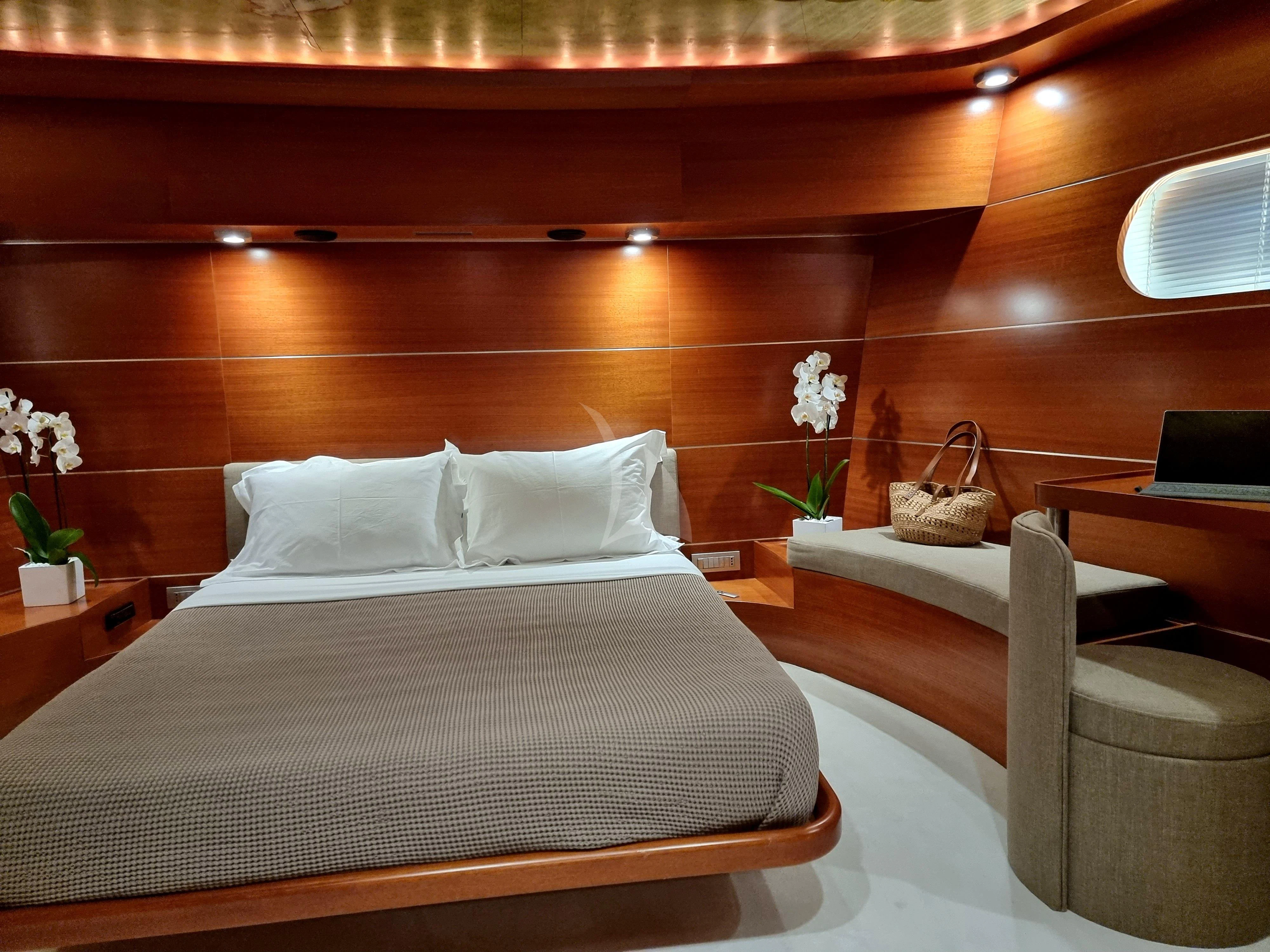 a bed with white sheets aboard SATORI Yacht for Sale