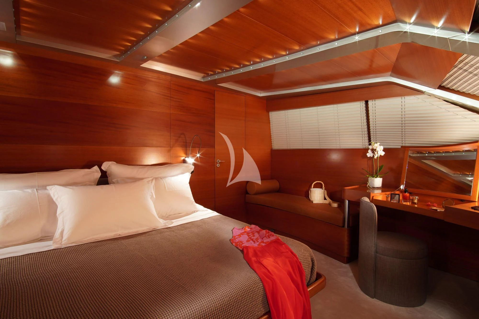 a bed with a white bed spread aboard SATORI Yacht for Sale